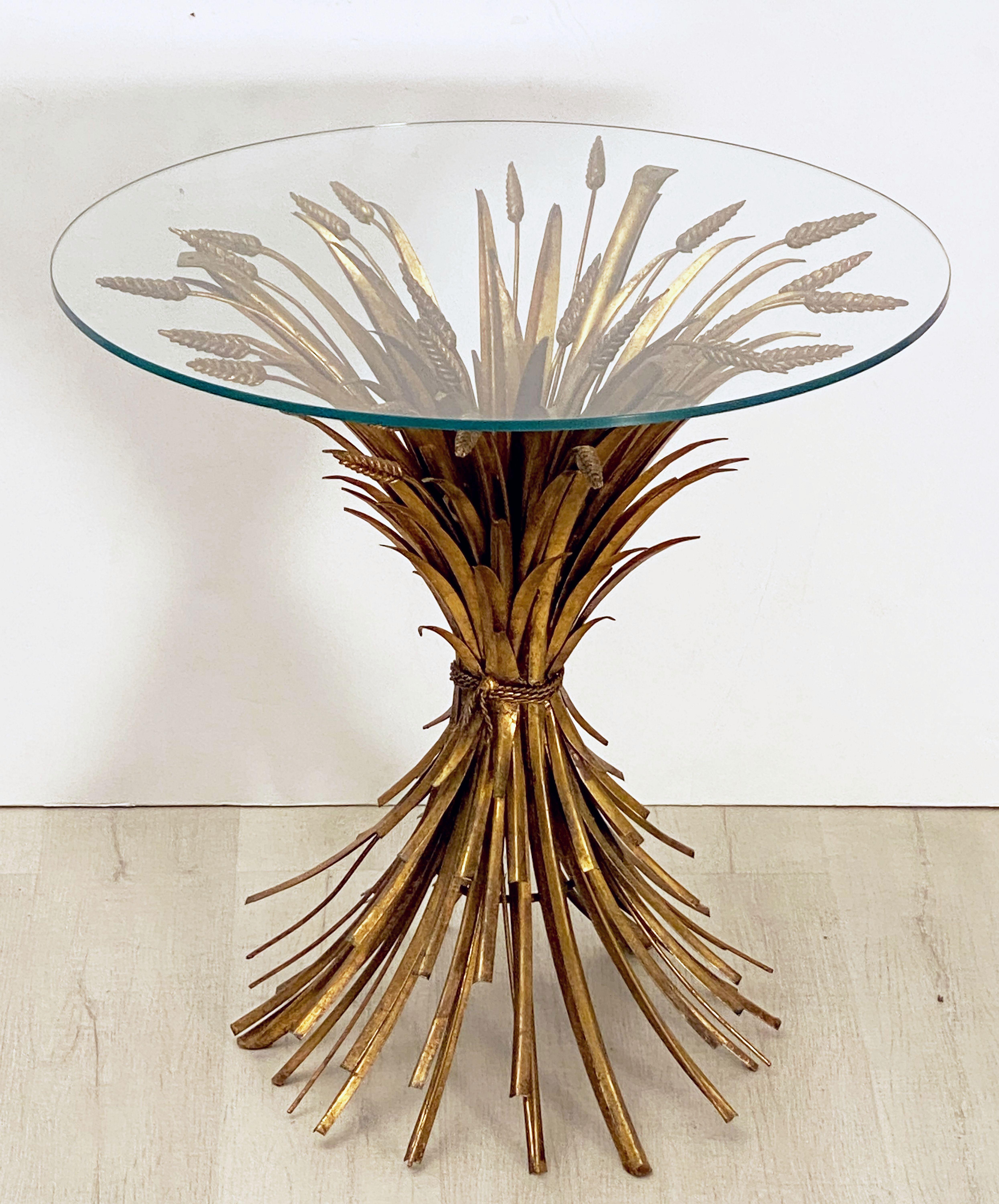 A lovely Italian wheat sheaf cocktail table and chairs set by S. Salvadori - Firenze. 
Featuring a wheat sheaf bistro table of gilt metal with a round glass top and a matching pair of chairs with elegantly detailed backs in the design of a sheaf of