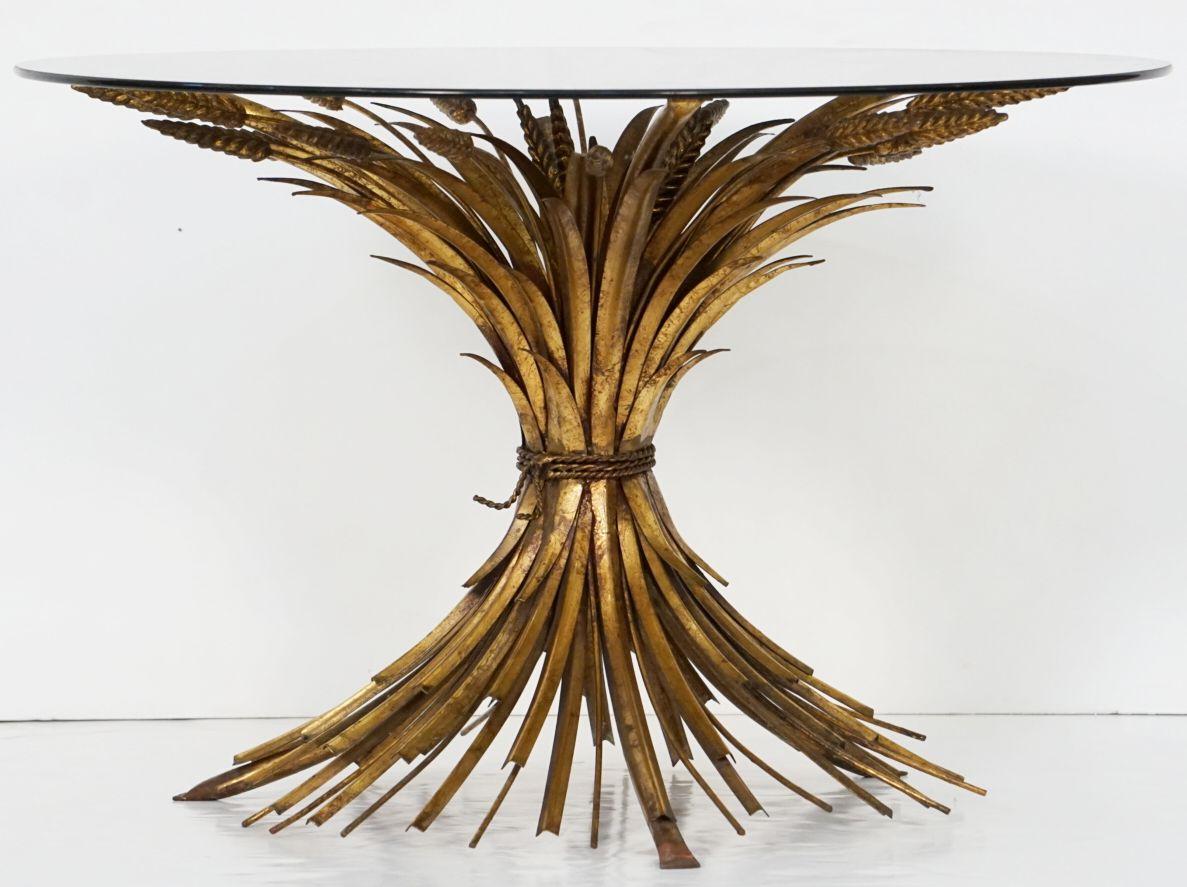 A fine Italian wheat sheaf cocktail or coffee table (or low table) from the Hollywood Regency era, featuring a round smoked glass top set upon a beautifully designed and constructed sheaf of wheat base, with original gilt finish. 

Perfect for use