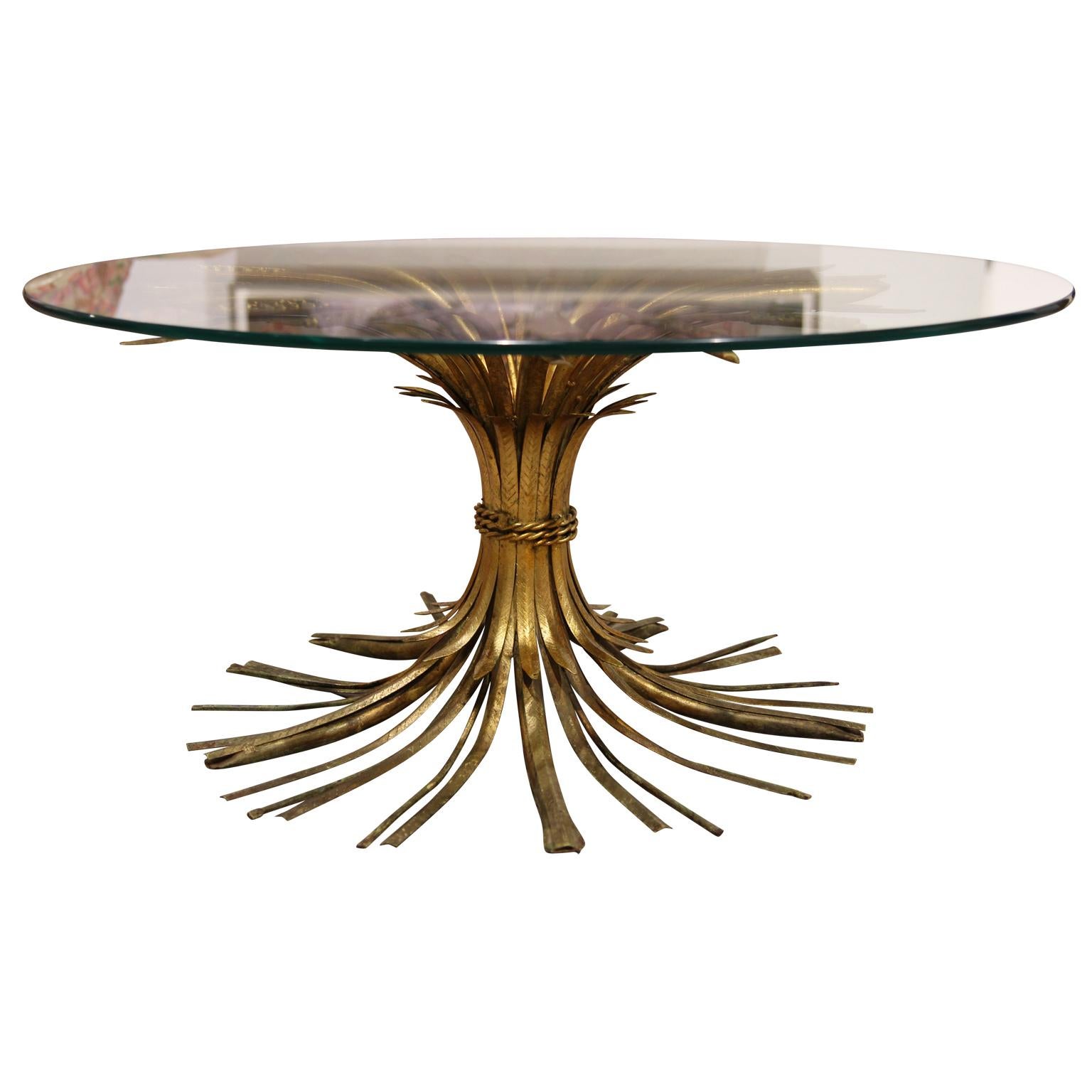Vintage Italian gold gilt iron wheat sheaf end table with round glass top. This high style table has been made famous by the likes of Coco Chanel and Yves Saint Laurent as they both had similar tables in their French Chateaus.