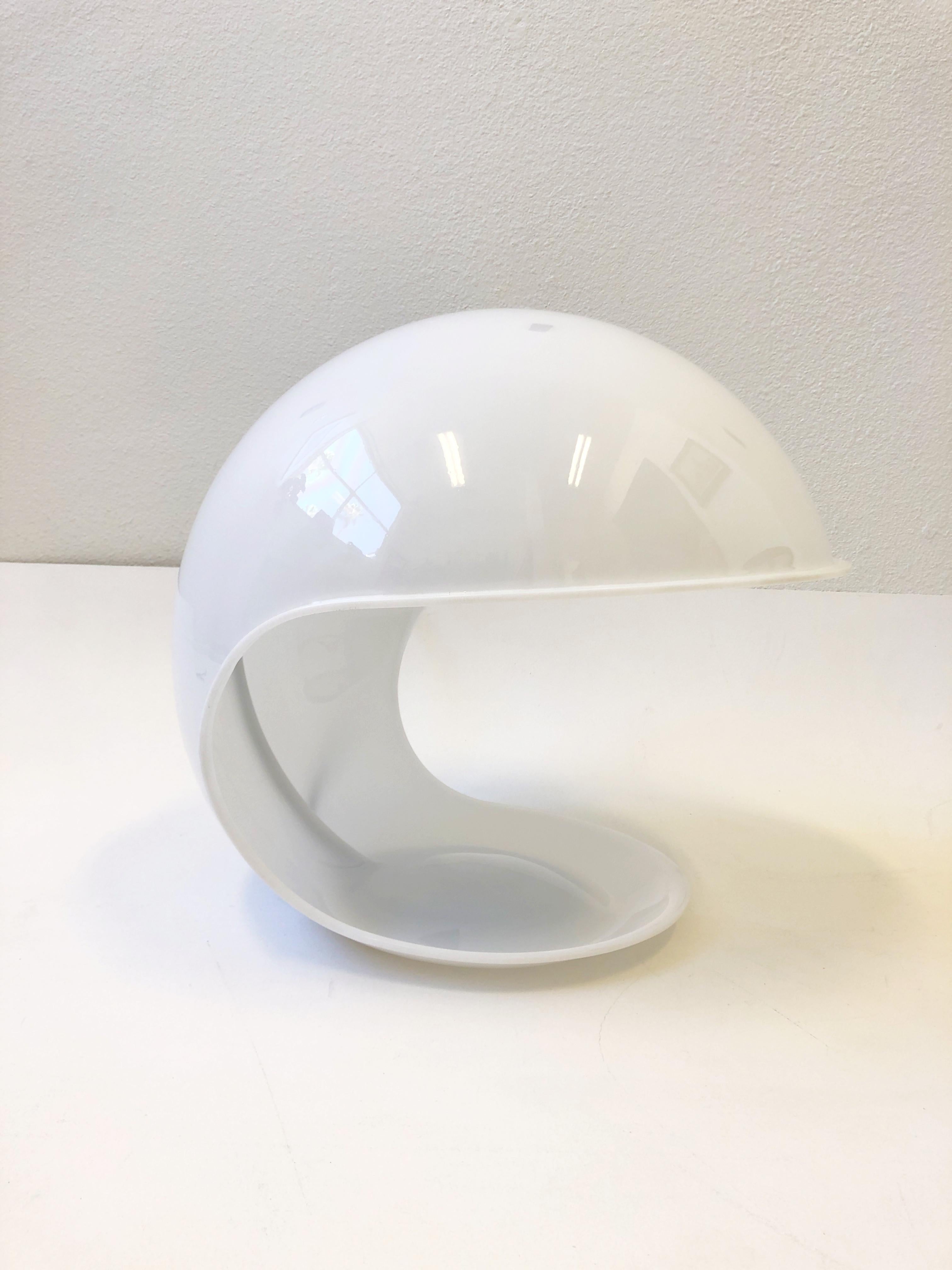 Polish white Acrylic “Flogia” table lamp design in the 1969 by Italian designer Elio Martinelli. 
It takes one regular 60m max Edison lightbulb.
 On/off in line switch. 
In beautiful condition. 
Measurements: 18” Deep, 18.25” Wide and 16” High.