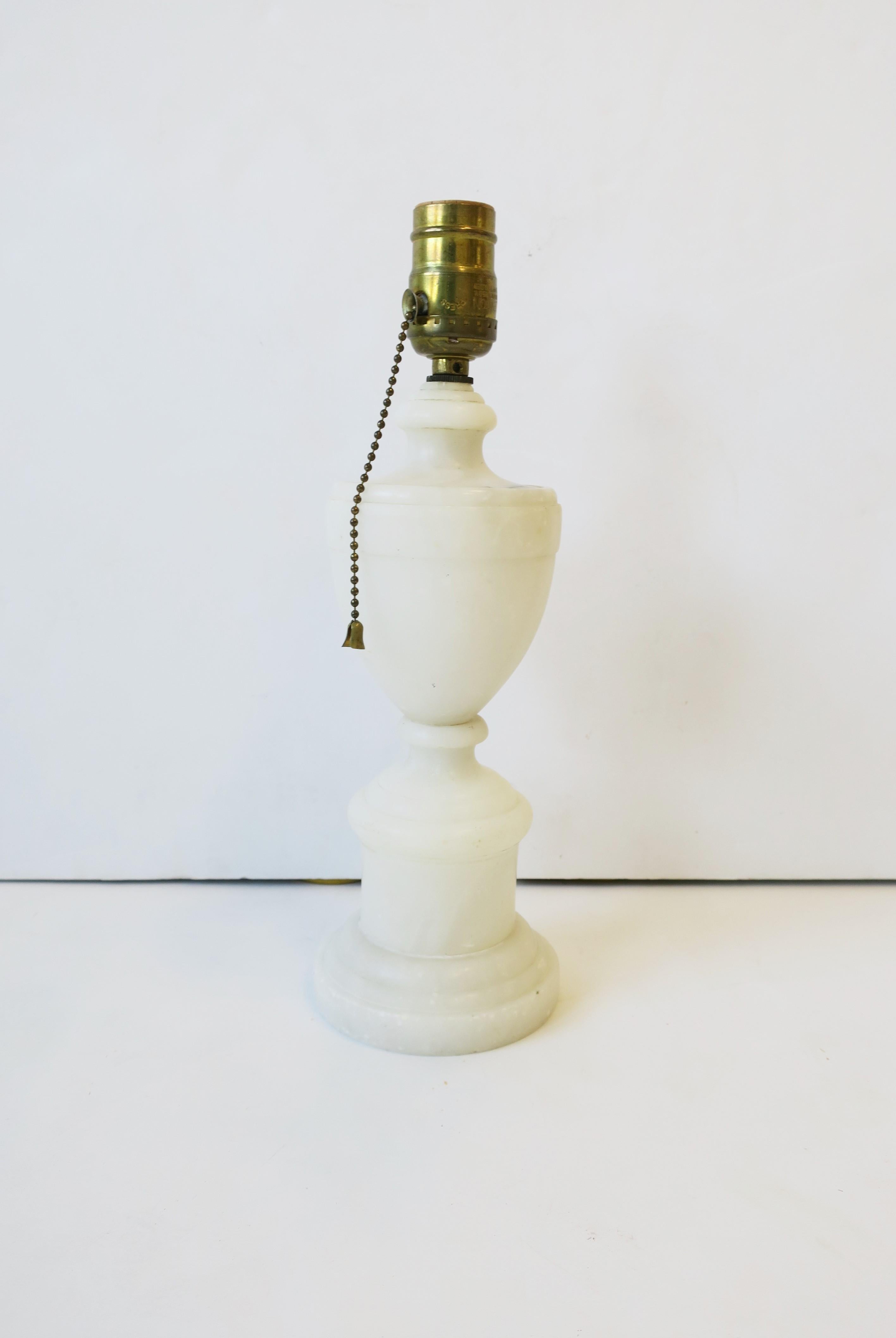 A neoclassical style Italian white alabaster marble 'Urn' form desk or table lamp, circa mid-20th century, Italy. This alabaster marble lamp is on the smaller side, with small brass bead on/off pull chain, and gold silk electrical cord. In fine