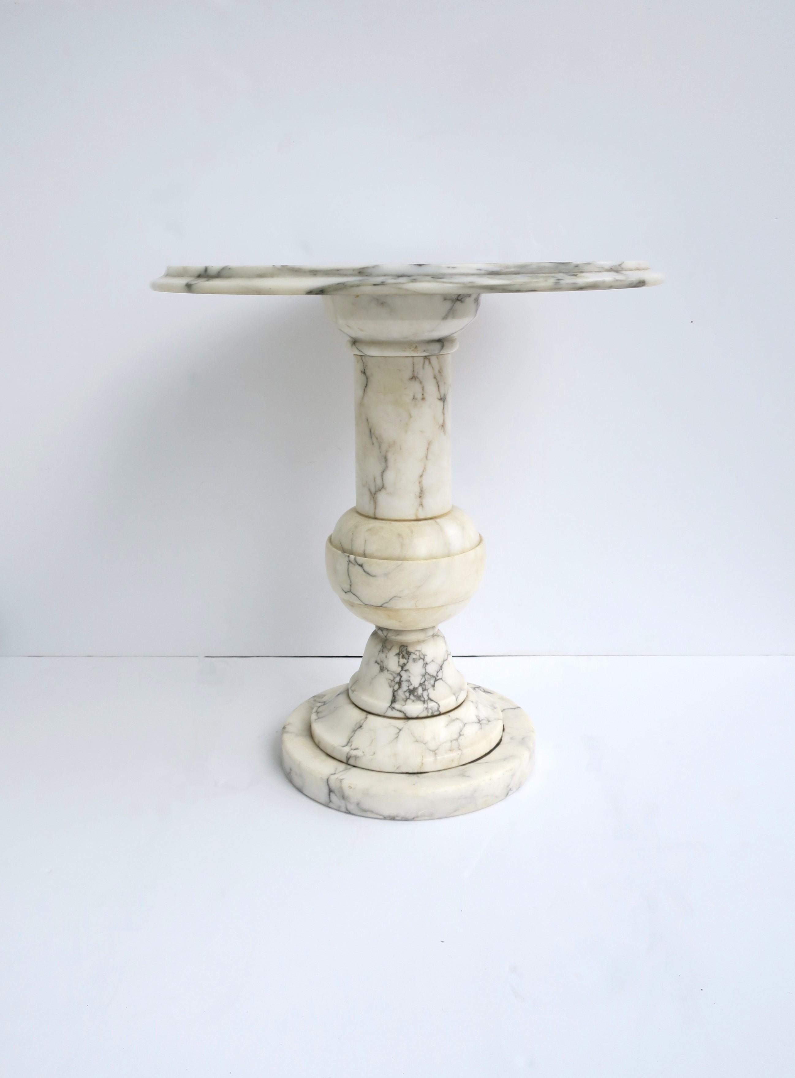 A substantial Italian round marble side or drinks table, circa mid-20th century, Italy. Marble is predominantly white with black and grey veining. A great table for drinks, cocktails, etc. Dimensions: 18