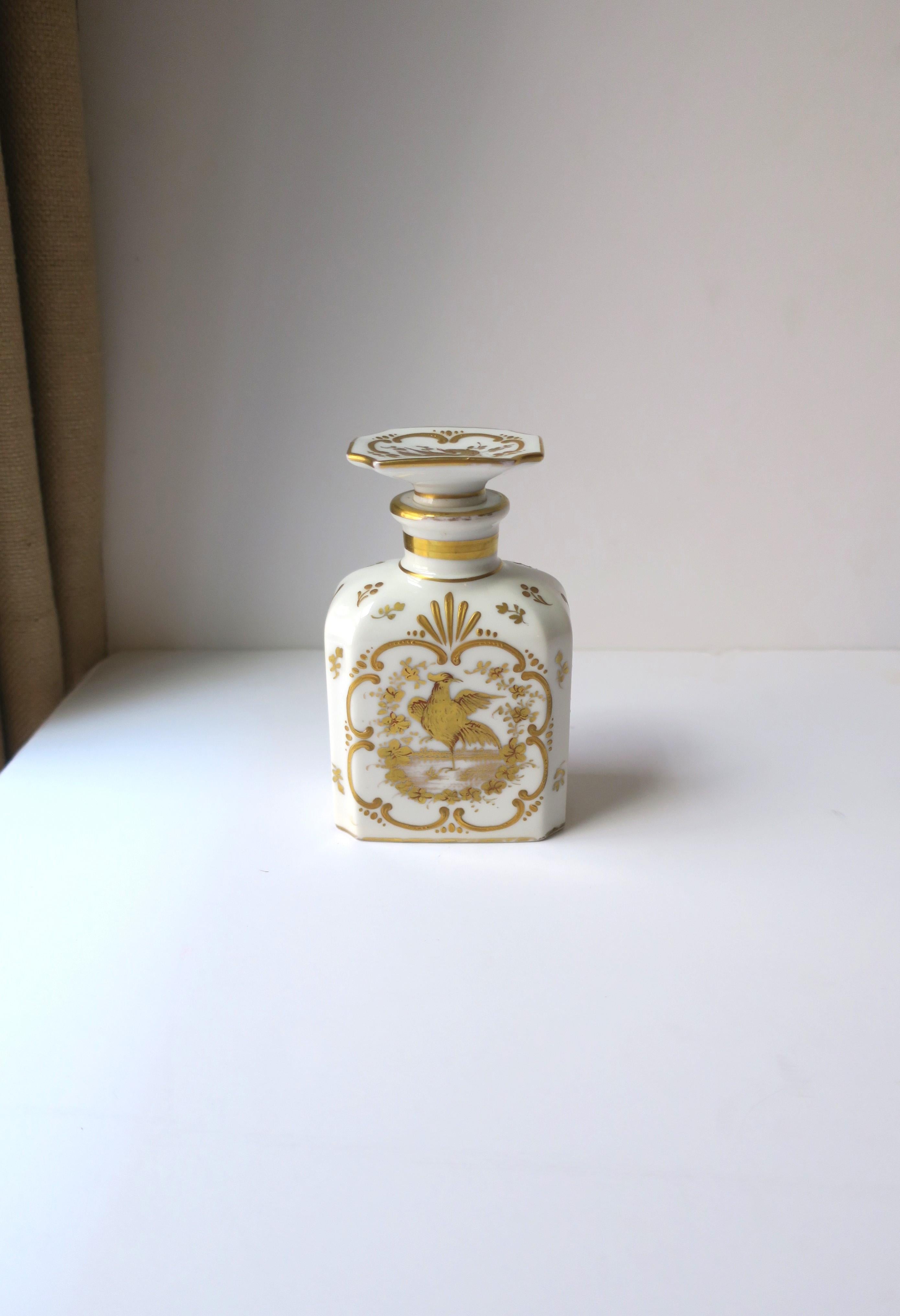 A very beautiful Italian white and gold porcelain vanity bottle with bird design in the Rococo style, circa early-20th century, Italy. A white porcelain bottle and stopper top with raised gold gilt relief, including a bird on front, back and on top