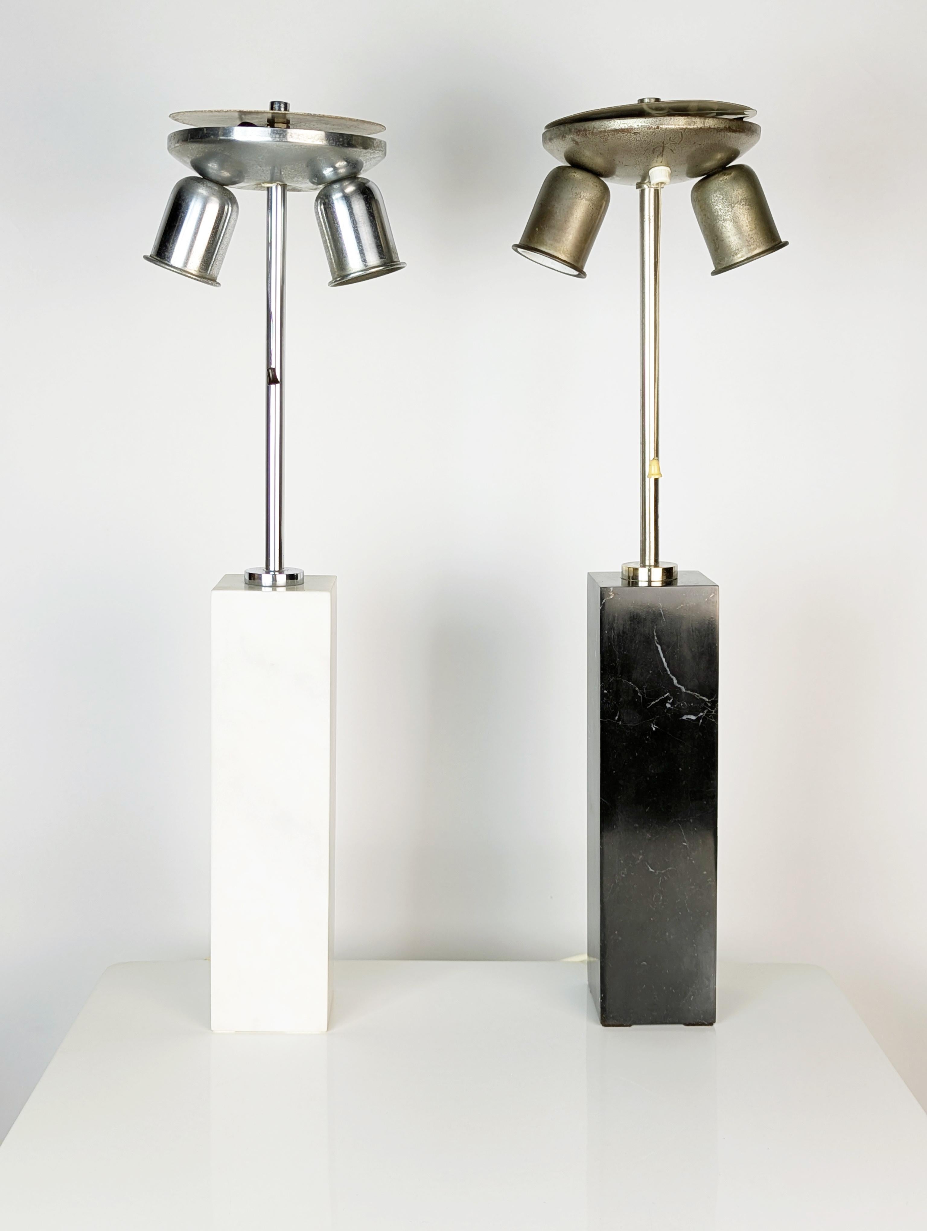 Pair of elegant table lamps/lampshades made in the 60s. Parallelepiped bases in black and white marble. Nickel-plated and chrome-plated metal frames equipped with 2 E27 lamp holders and a cord switch. One lamp is slightly higher (0.5 cm).
The bases