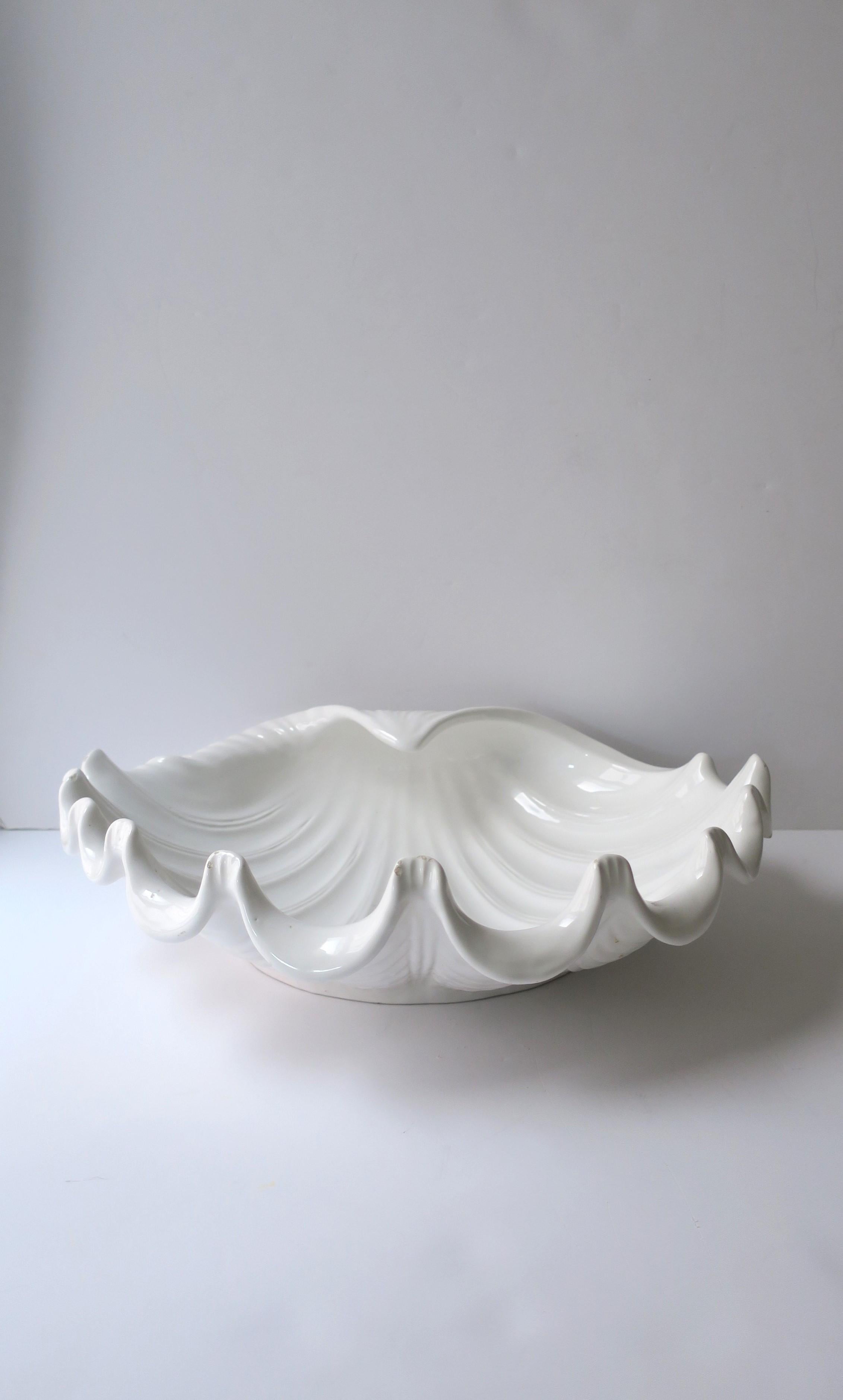 An Italian white ceramic seashell clam shell centerpiece bowl, circa late-20th century, Italy. A detailed white ceramic seashell: great as a standalone piece or fill with your favorite fruits, vegetables, seashells, flowers, etc. Piece is marked