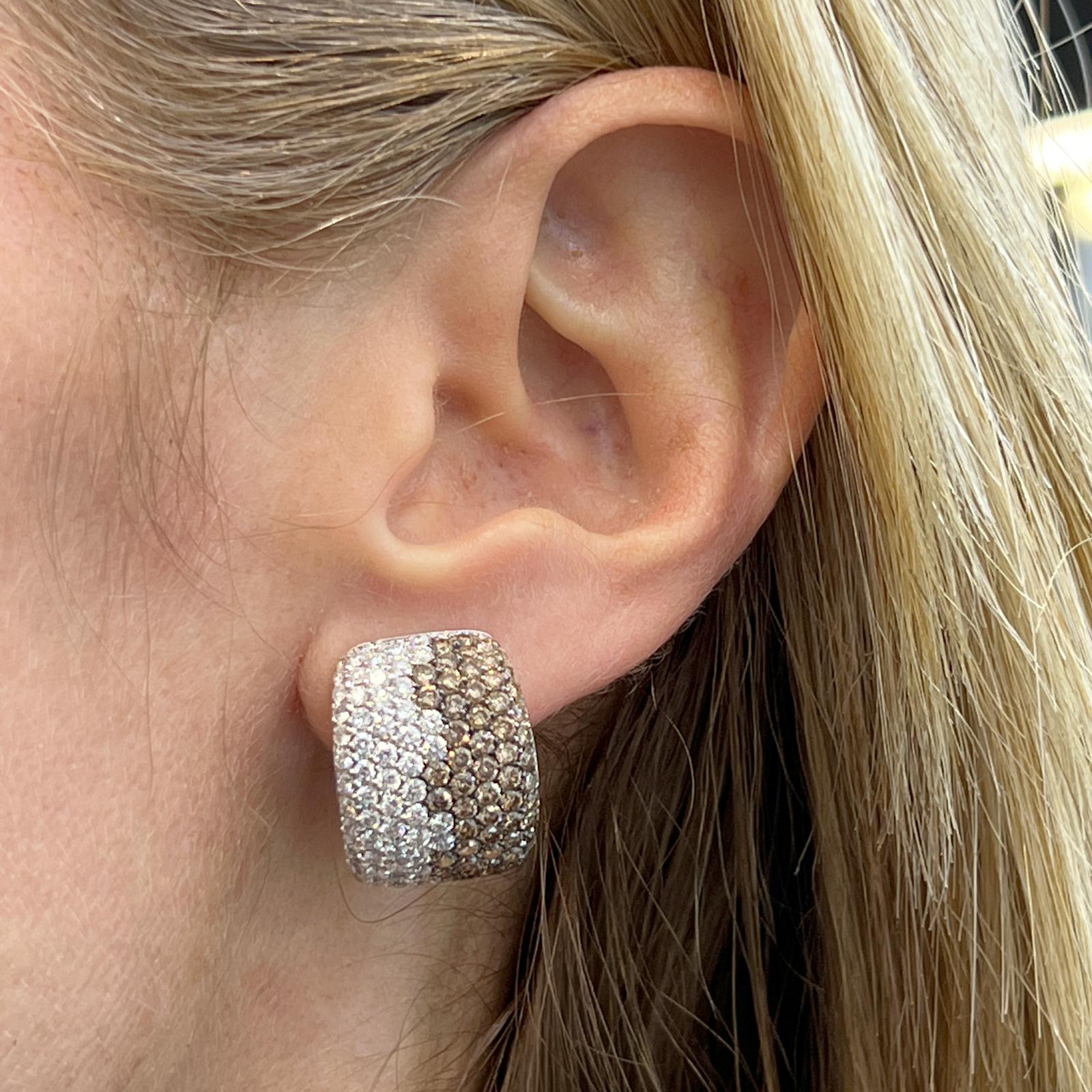 Stunning Italian diamond earrings crafted in 18 karat white gold. The earrings feature 224 round brilliant cut white diamonds weighing approximately 6.72 CTW and graded F-G color VS clarity. Another 224 champagne color diamonds weigh approximately