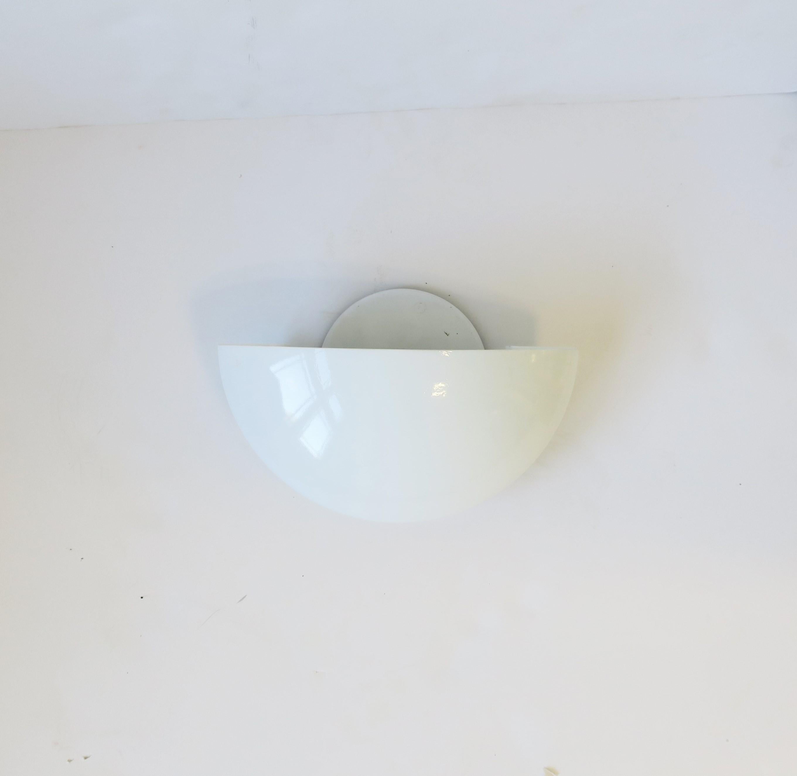 A single Italian white glass and metal wall sconce in the Art Deco style by Rialto, circa late-20th century, Italy. With maker's mark as shown in images. Max bulb 75W as marked. Good for indoor or an outdoor covered area as marked on label. No chips