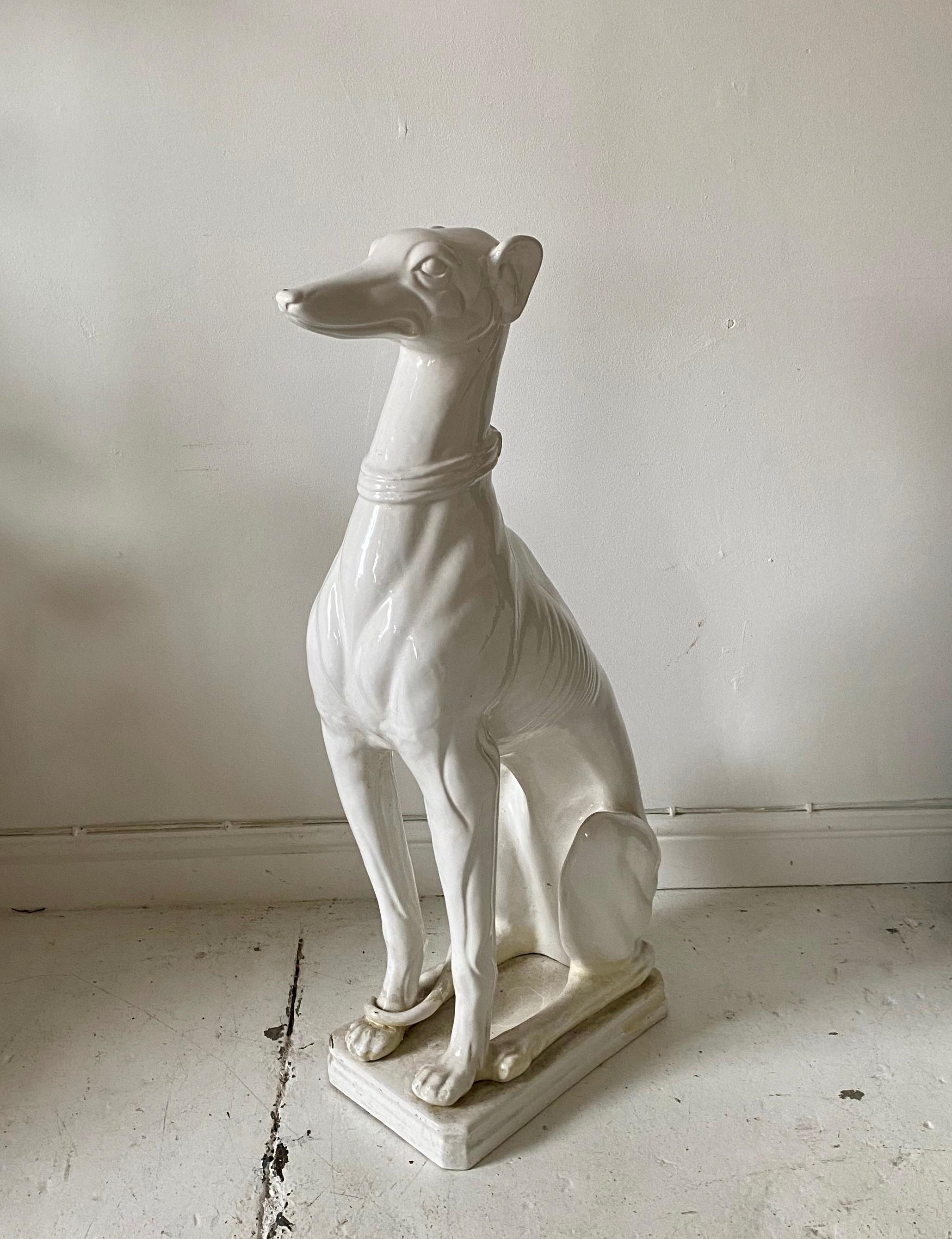 A beautiful midcentury Italian white glazed seated greyhound dog, this wonderful piece is life-size. A fantastic piece for any room.