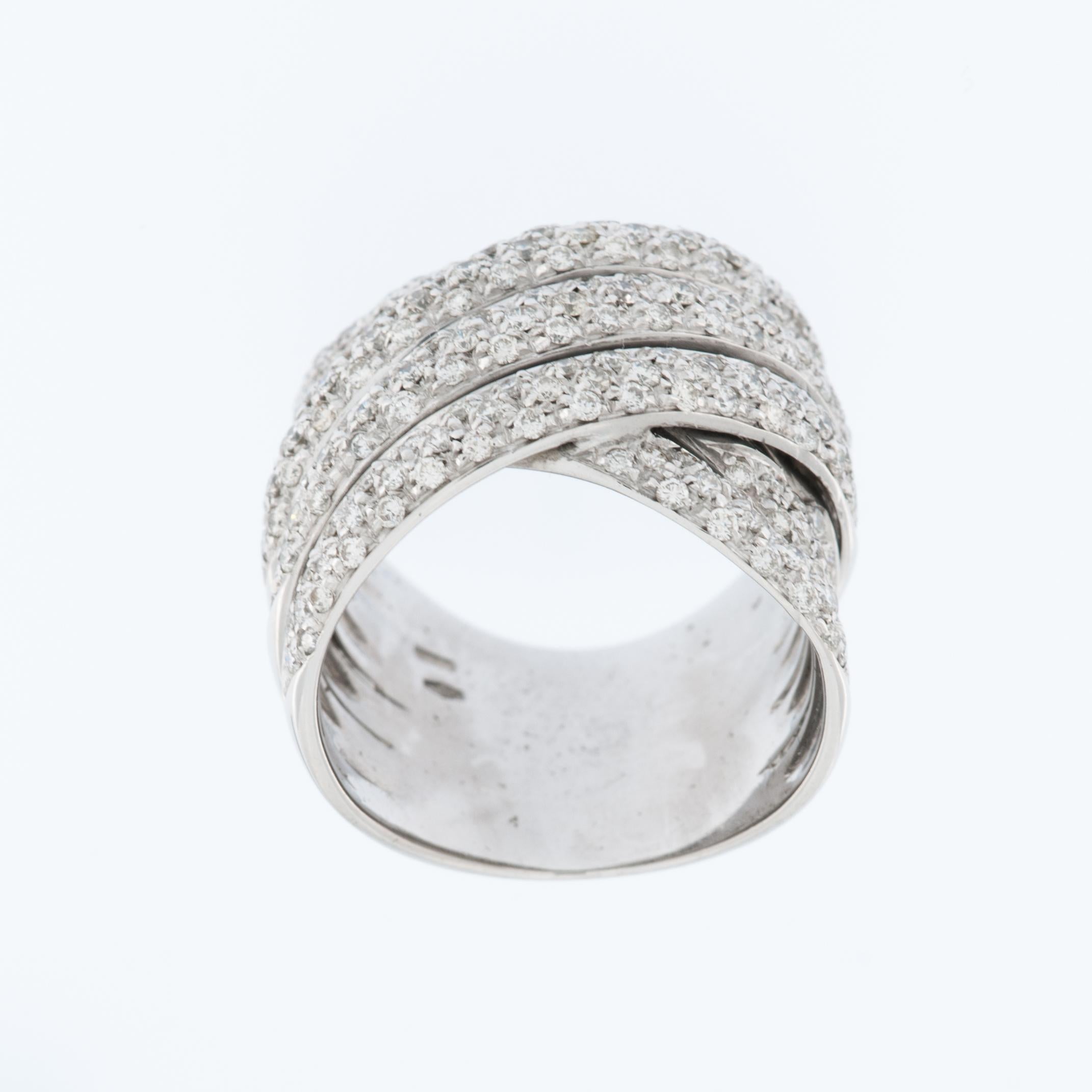 The Italian diamond ring features an 18kt white gold crossover bands with a bead setting. This design entirely in white gold, creates a unique and modern look.

The crossover band style typically involves two or more bands that intertwine or cross