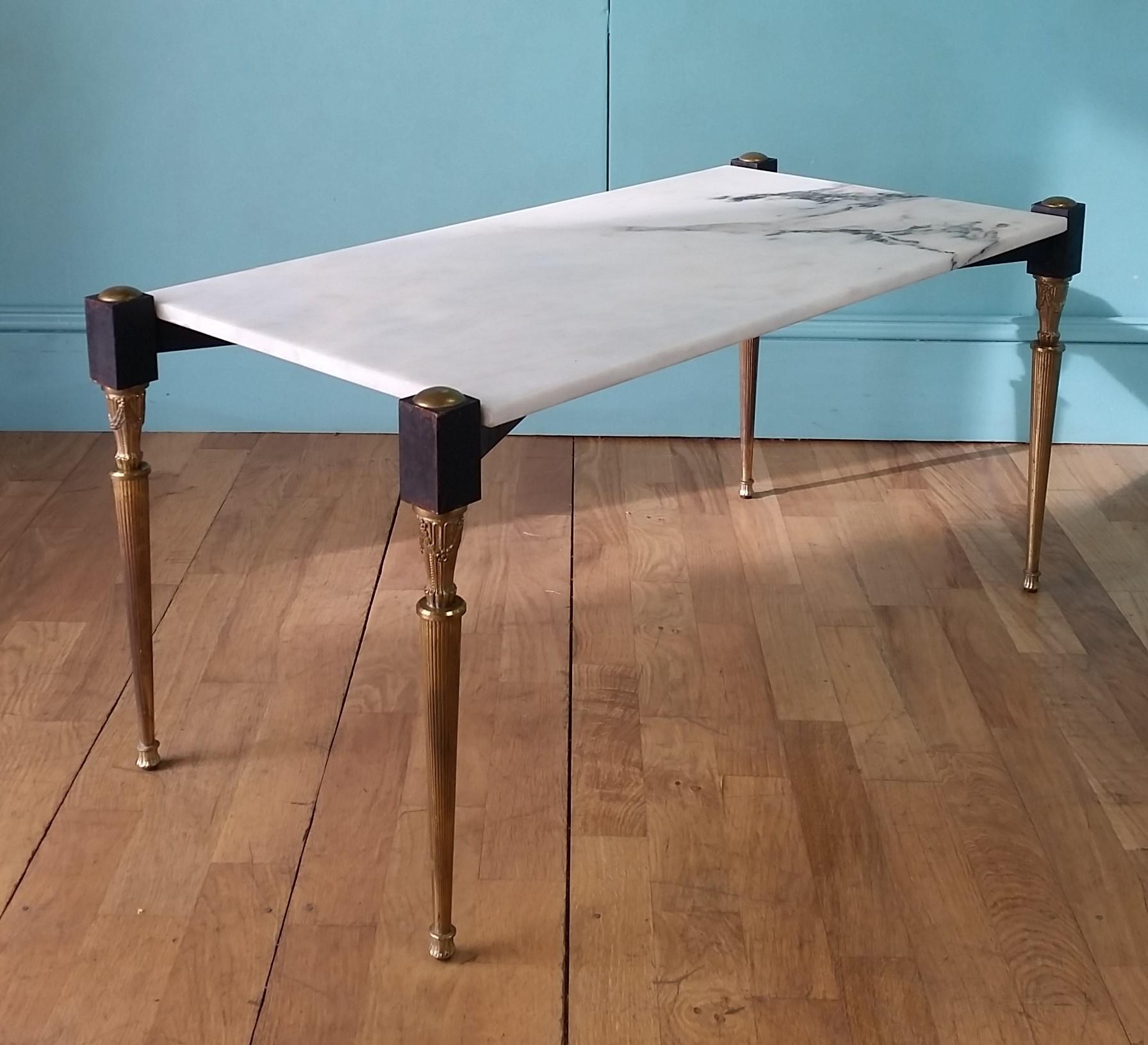Italian mid century coffee table circa 1950's
Decorative brass legs with a steel cross stretcher base support a white marble top.
In lovely authentic condition with a natural tarnishing of the brass and an aged wear to the original black
