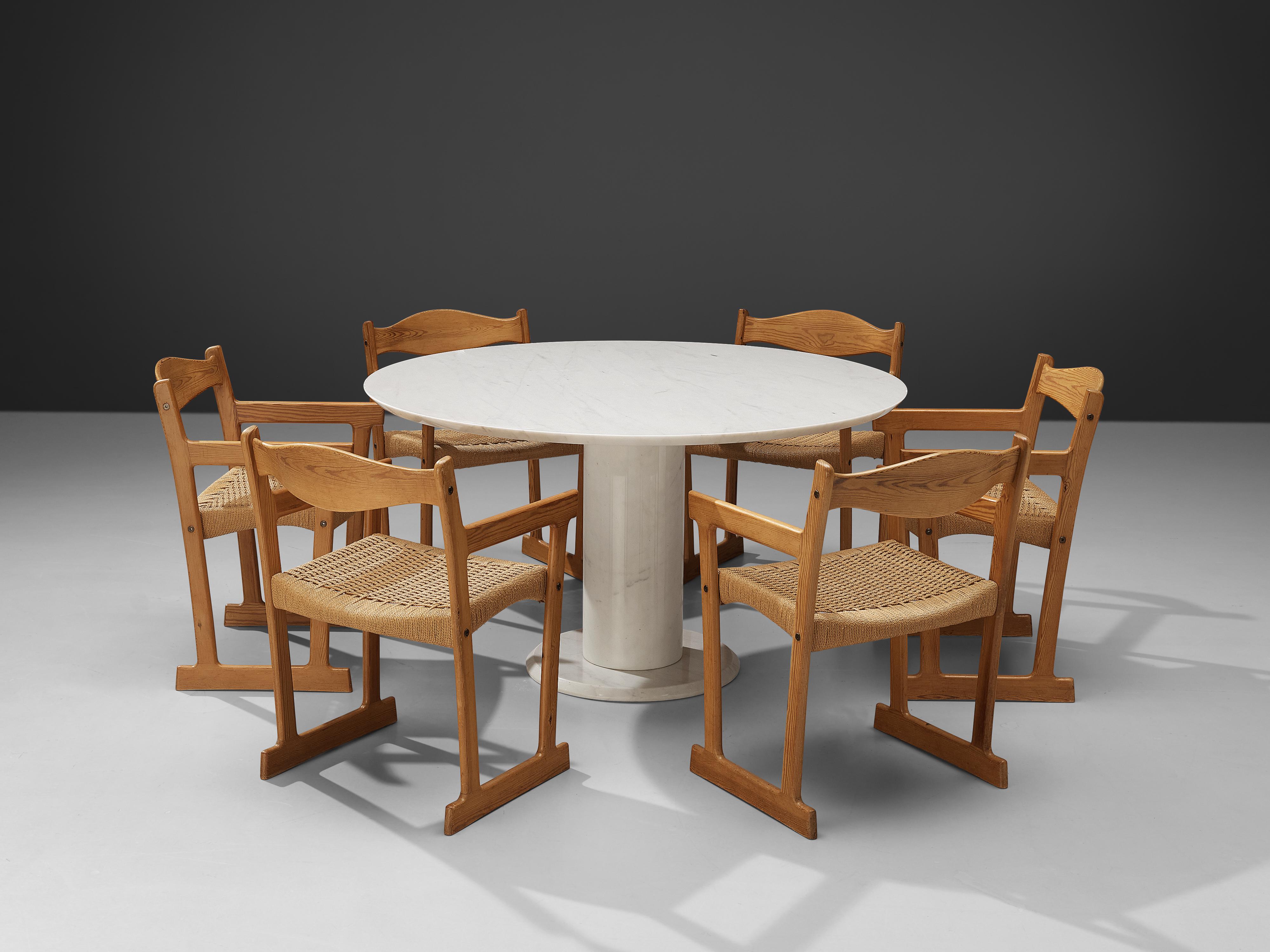 Round dining table, white marble, Italy, 1960s
This wonderful combination of wooden dining chairs around a round marble table forms a striking combination of colors and textures. The pedestal table stands on a cylindric base and a round feet. With