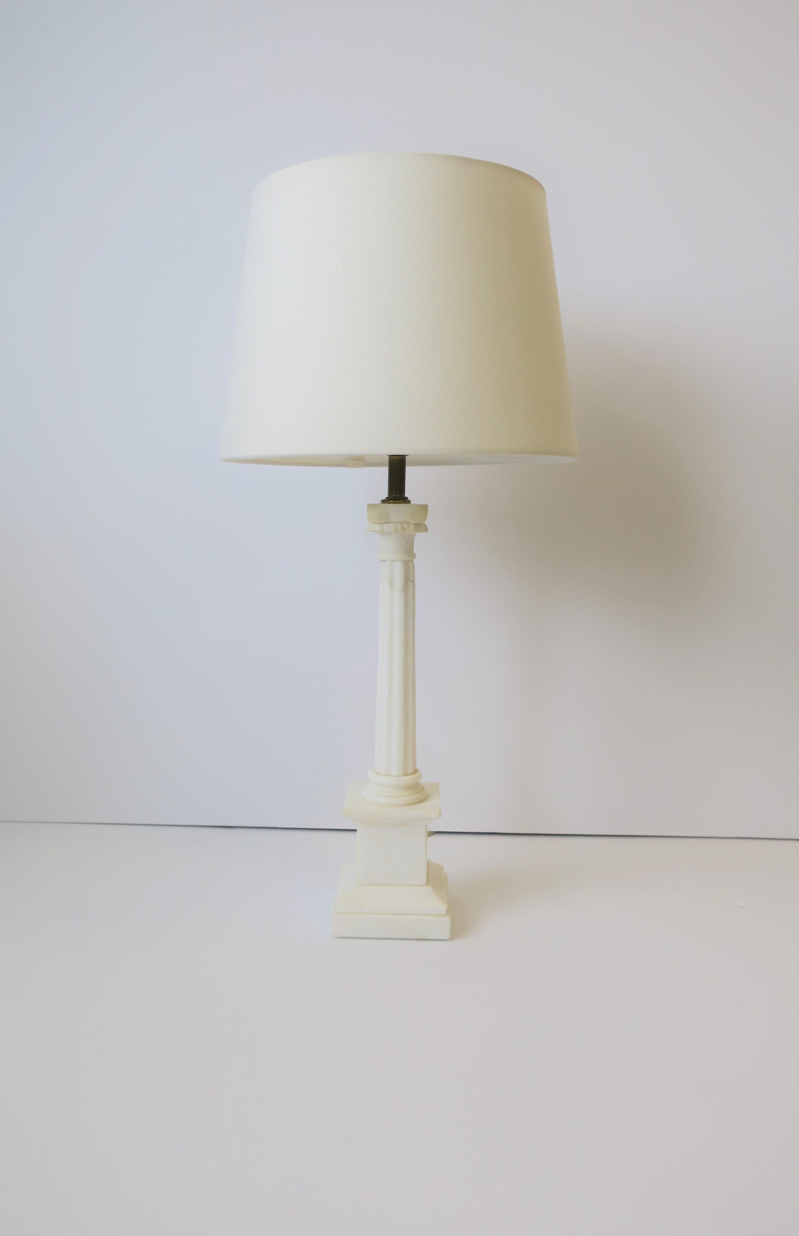 A beautiful Italian white marble Ionic column pillar, Neoclassical style, desk or table lamp, circa mid-20th century, Italy. Marble is carved and polished smooth. 

Lamp measures: 
20.75