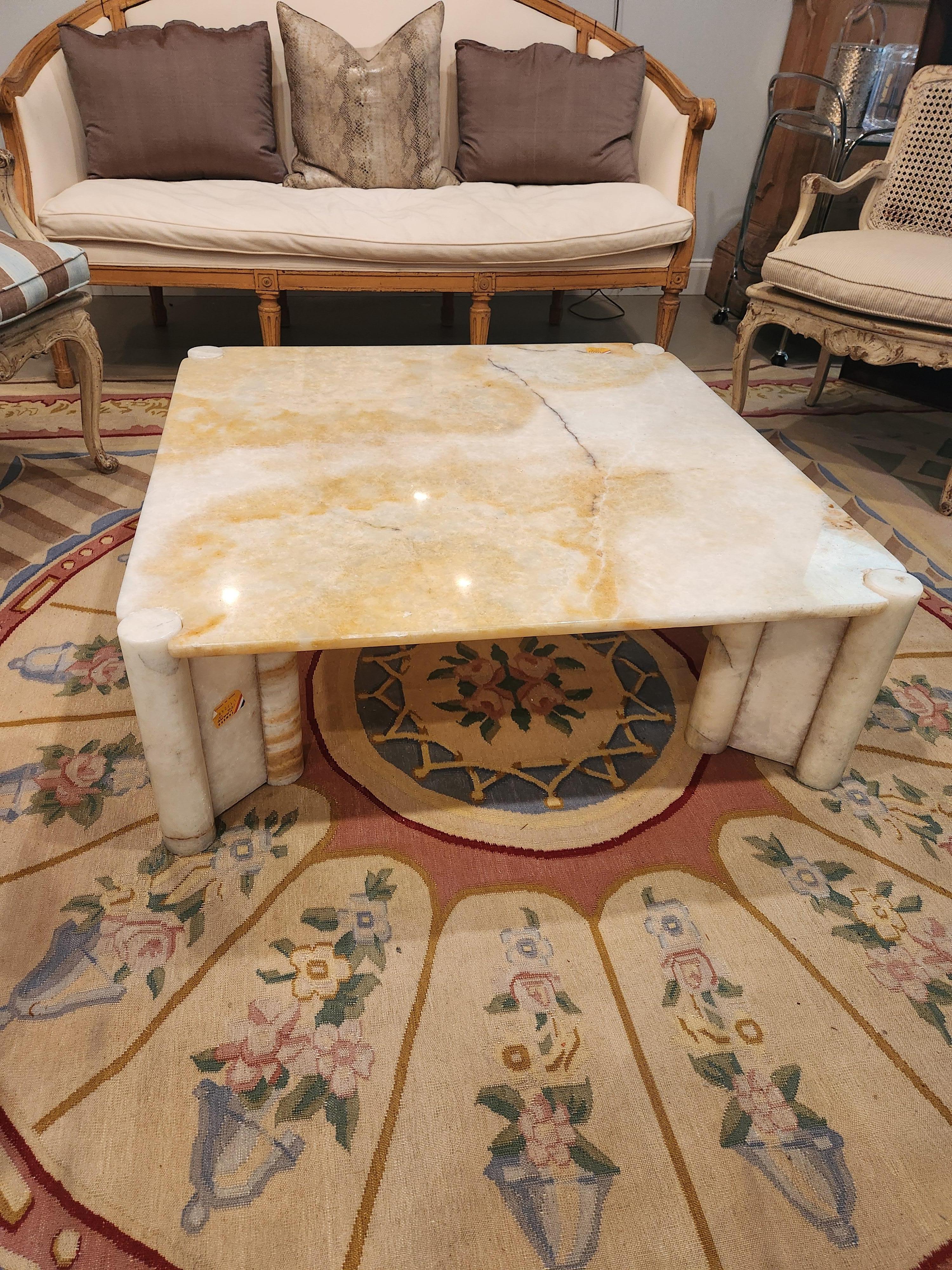 This solid onyx coffee table comes in 5 pieces.  Each leg fits the table like a puzzle. Made of polished onyx which showcases it's natural veining in tones of amber, beige, ivory and hints of charcoal gray. The top is a thick solid slab with rounded