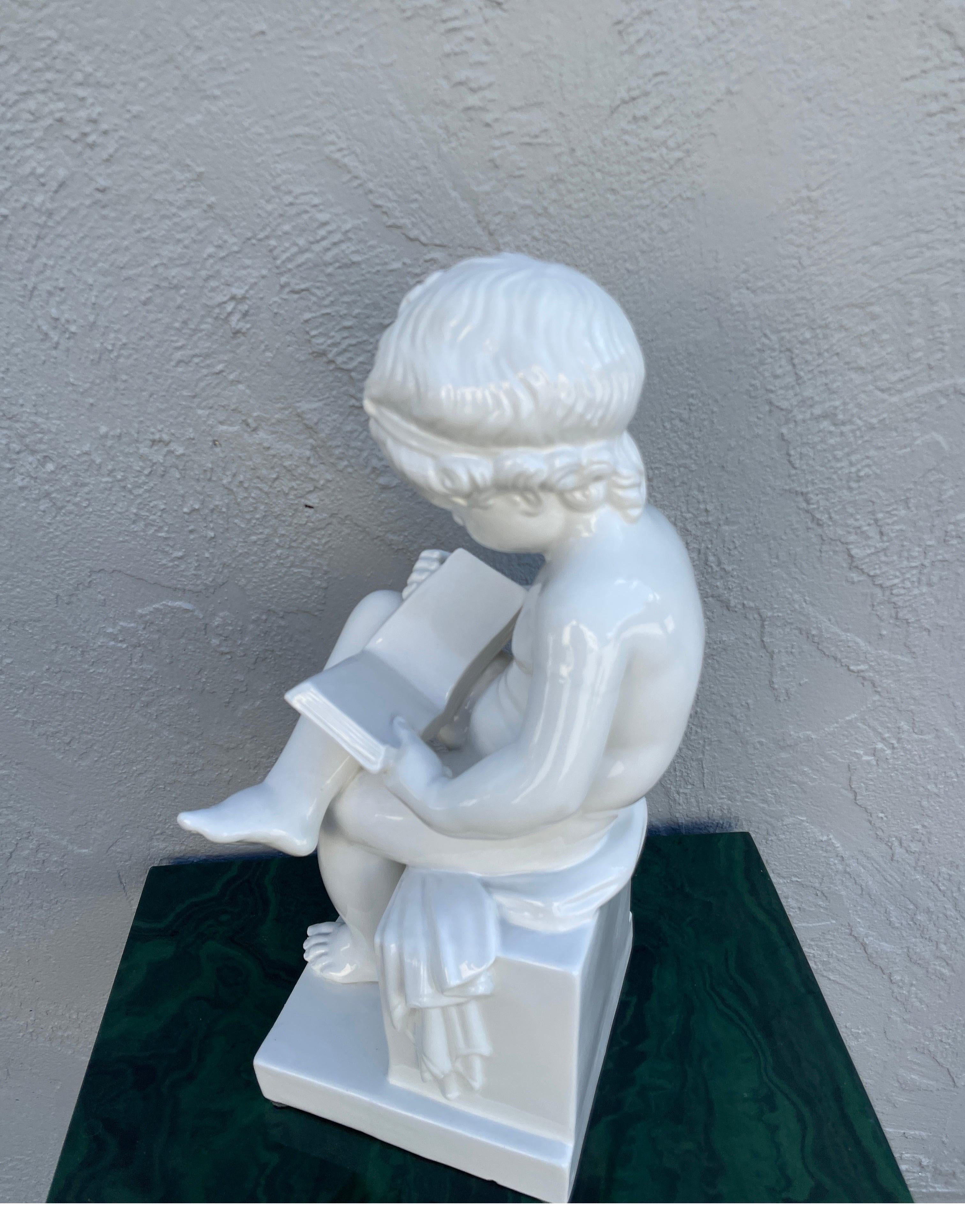 Italian White Porcelain Seated Putto Reading a Book For Sale 1