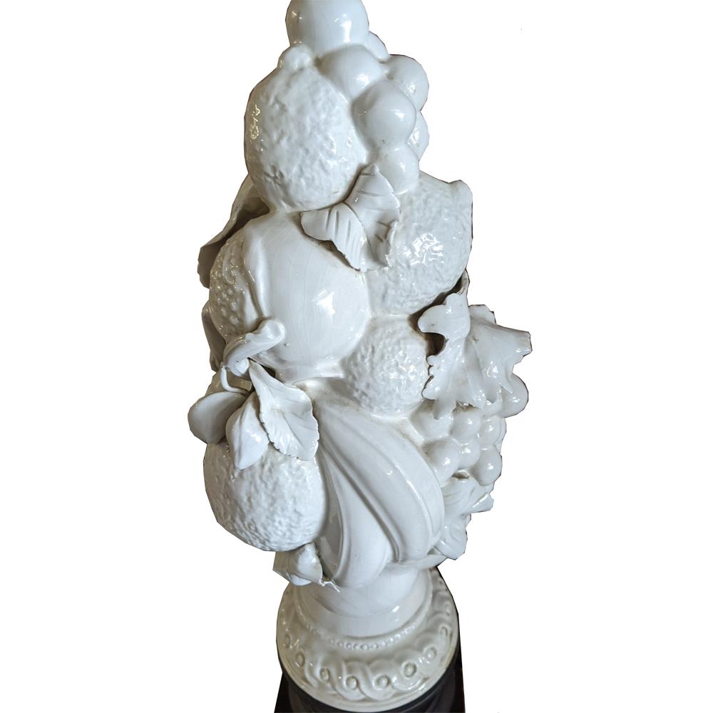 White porcelain Italian topiary lamp on ebonized base. Detailed with a variety of fruits. Shade not included.