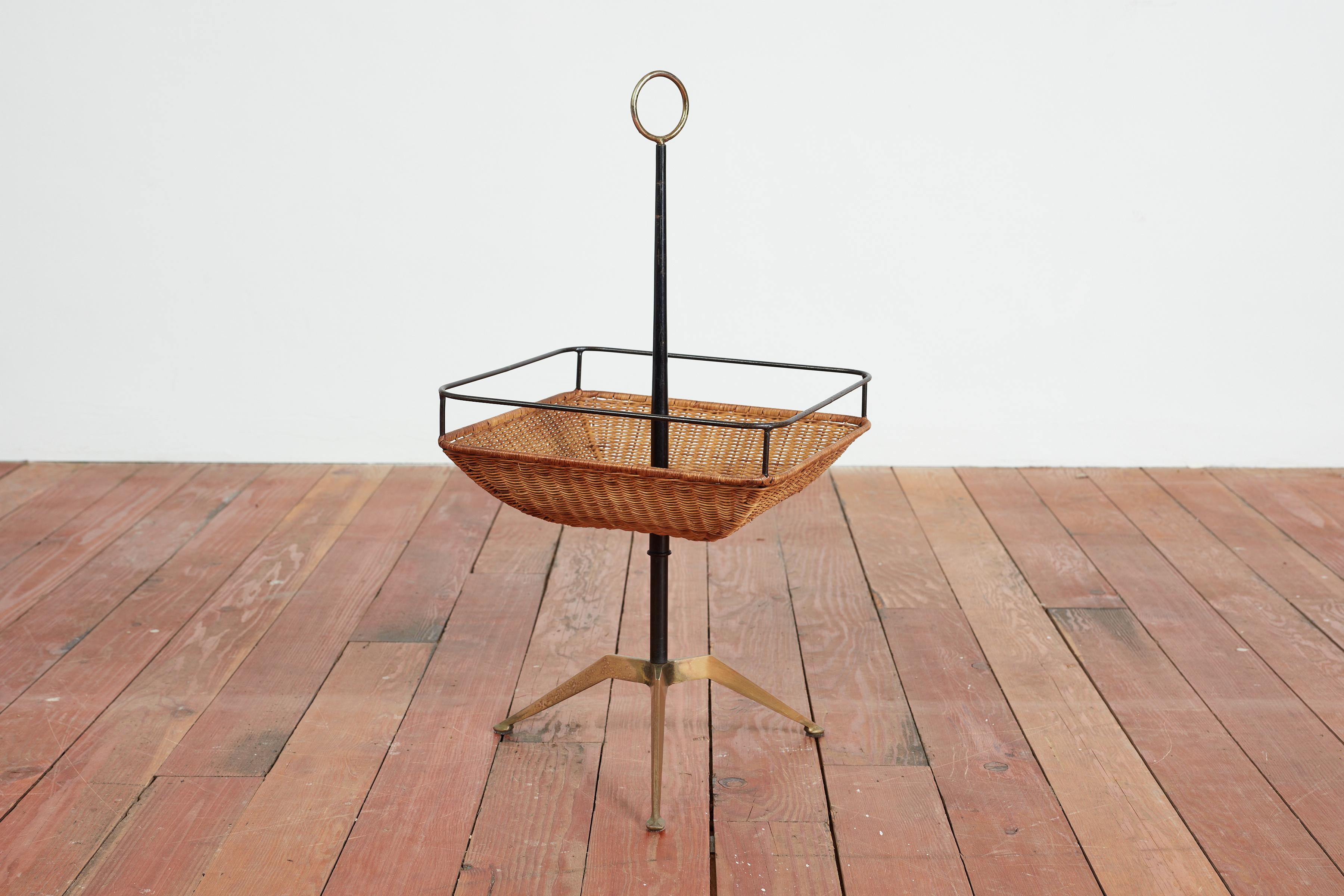 Fantastic Italian catch all with iron stem, brass tripod base and square shaped wicker basket that swivels with brass loop on top. 
Perfect combination of form and function - can be used for anything like keys, magazines, clickers  - you name it!