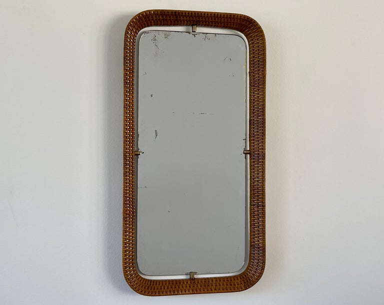 Italian wicker mirror with brass clasps and original mirror.