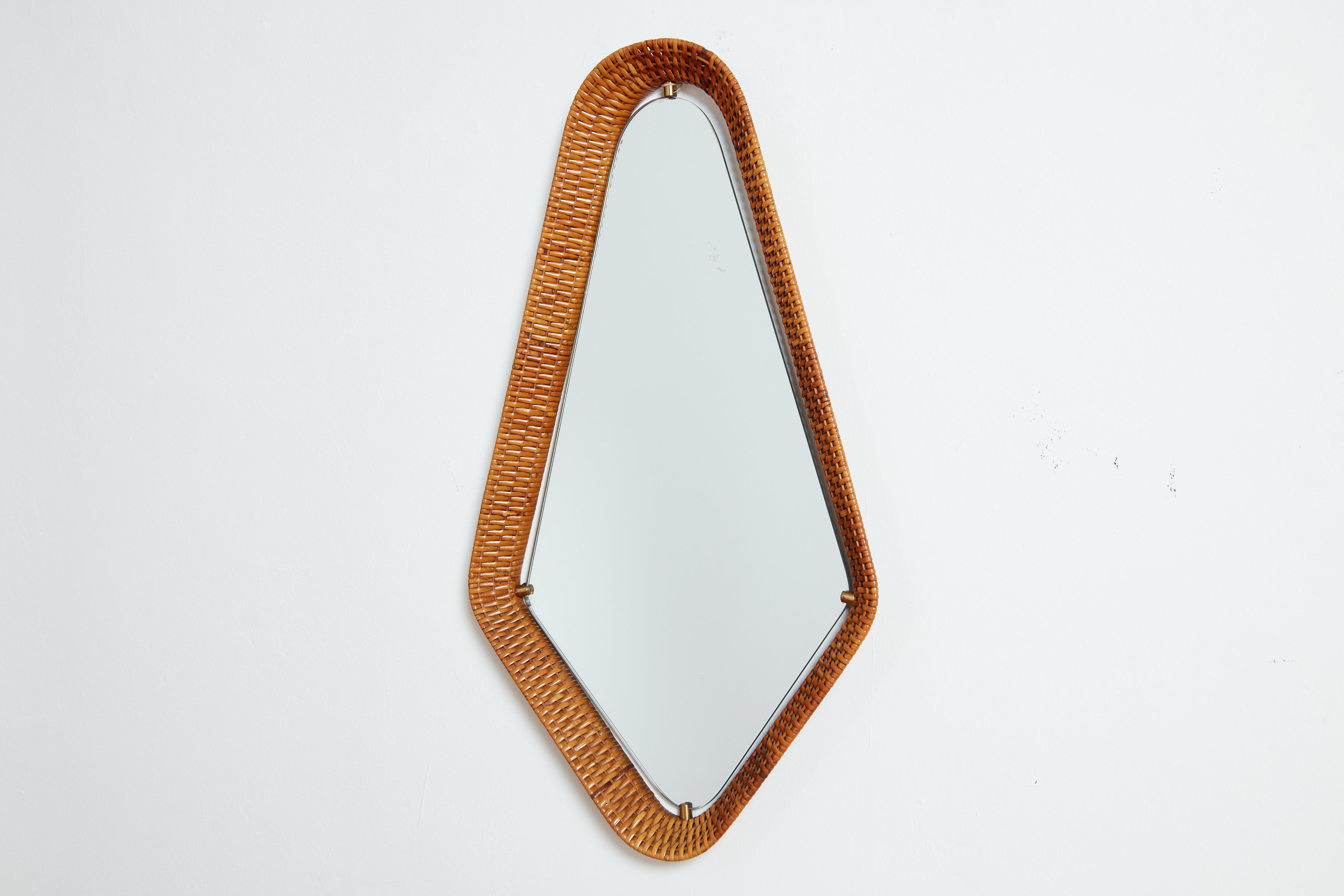 Italian woven wicker mirror in wonderful diamond shape 
Brass clasp hardware with floating mirror 
Great patina.