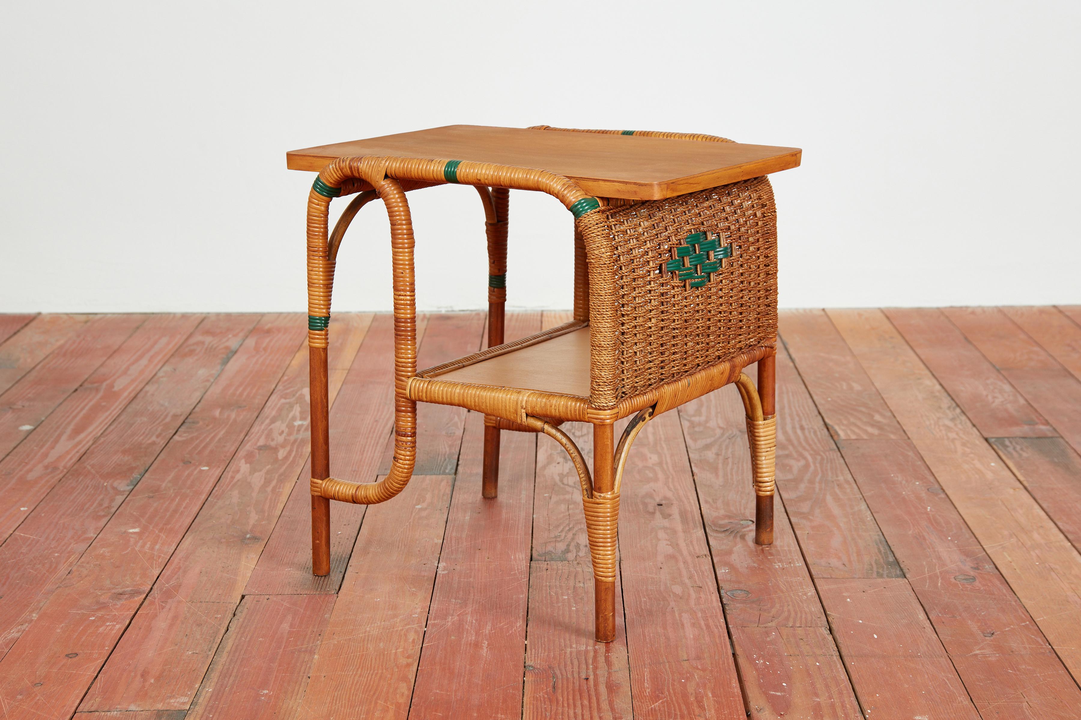 Italian bamboo and wicker side table  - Italy, 1950s
Curved bamboo structure with 2 wooden shelves wrapped in wicker with blueish/ green detail throughout. 

