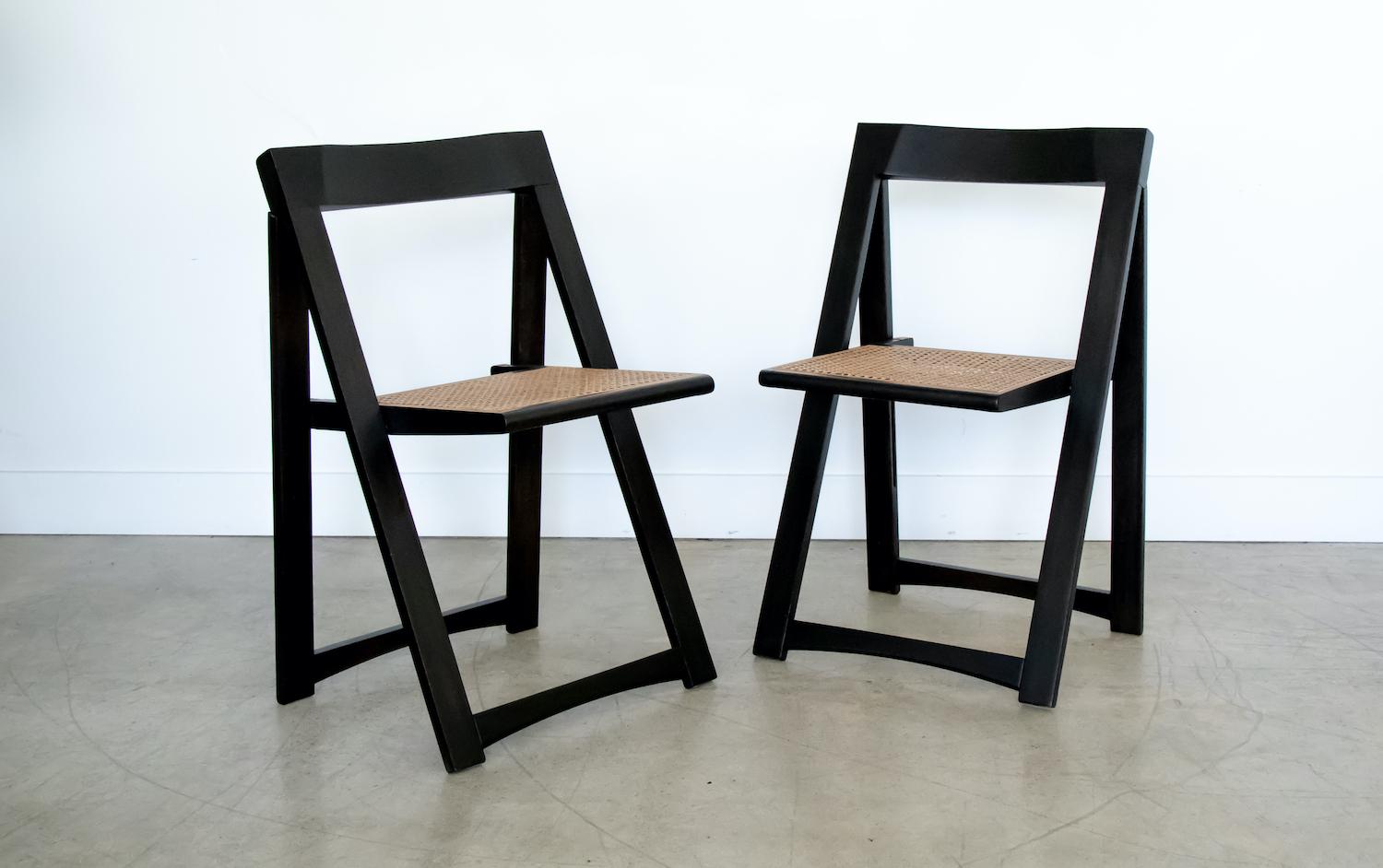 Pair of Italian wood and cane folding chair by Aldo Jacober from Italy, 1960's. Wood has been newly refinished in black, original cane seat. Sold as a set of two. 