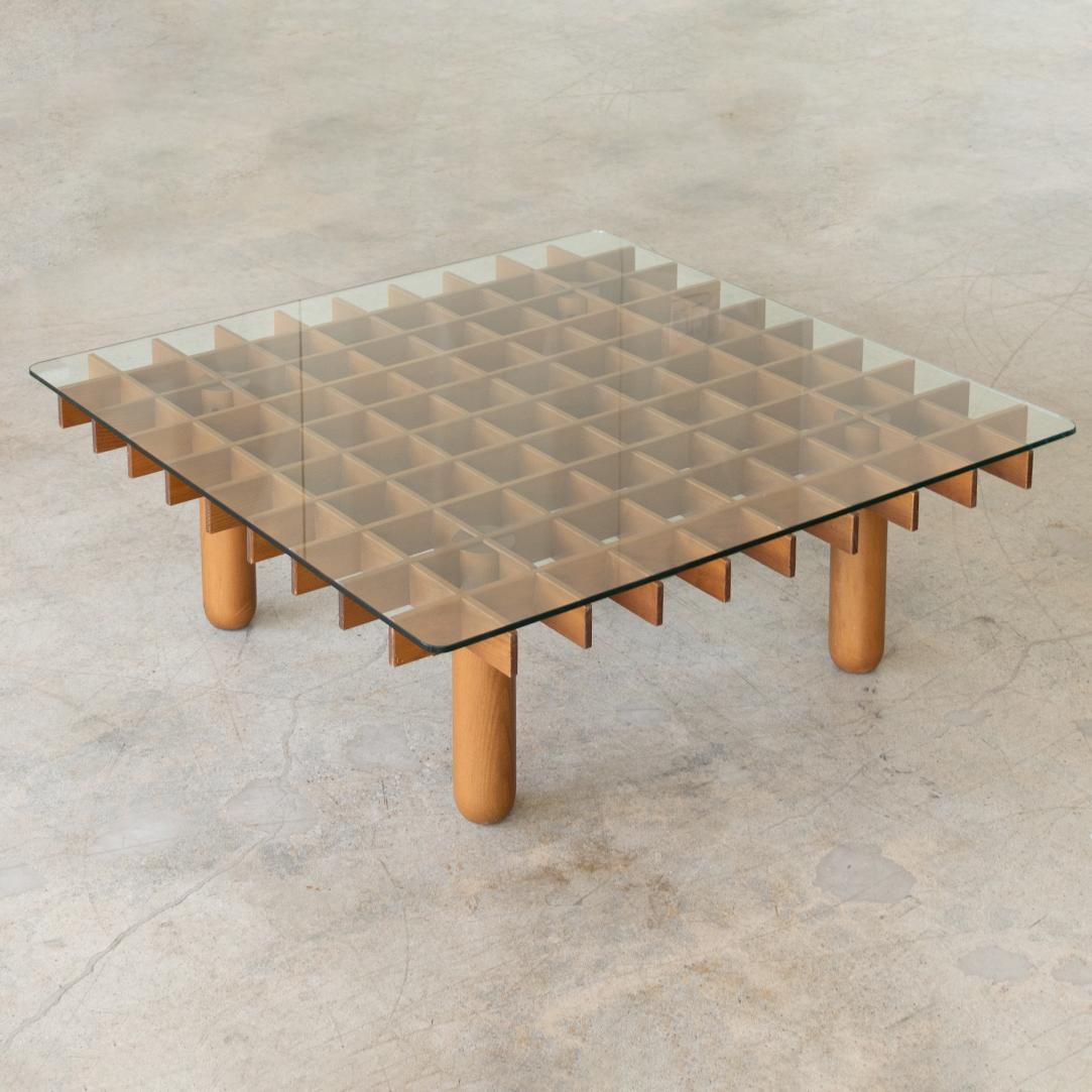Italian mid-century wood and glass square coffee table from the 1970's in the style of the ''Kyoto'' table by Gianfranco Frattini for Knoll. Wooden grid top on four solid wood legs and clear square glass resting on top. Great vintage condition.