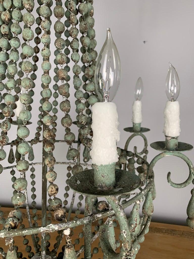 Italian Wood beaded '8' Light Chandelier In Distressed Condition For Sale In Los Angeles, CA