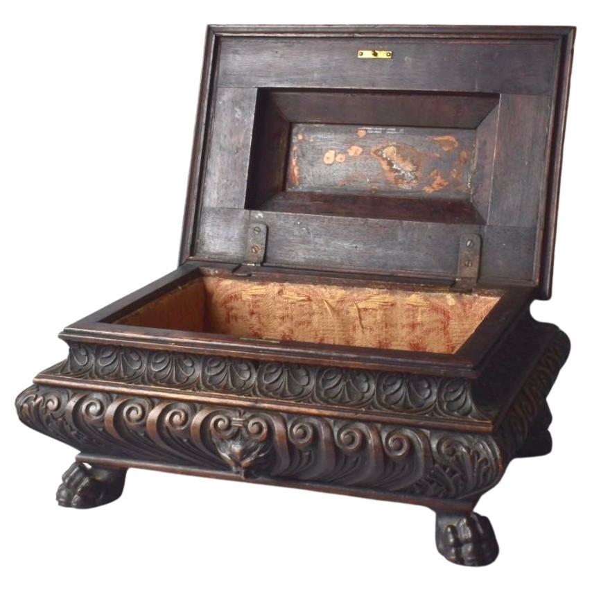 19th century Italian wooden carved casket box in the baroque style. Features gothic faces and lions paw feet. Can be used as a jewelry or trinket box or as decor. 
