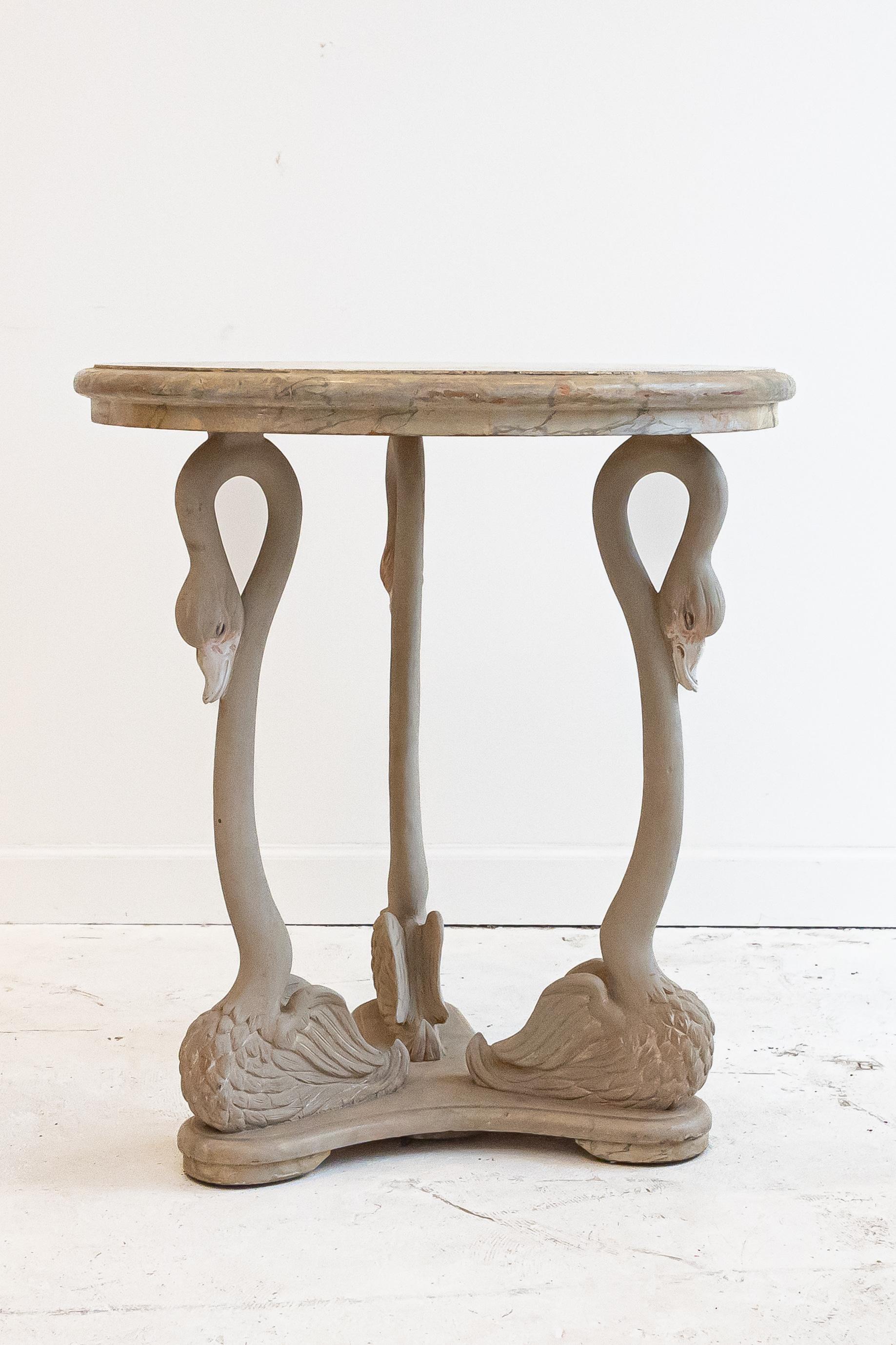 This hand-carved and painted accent table was created by a master craftsman and artist in Italy. The faux marble painted wood top adds an elegant finish. 