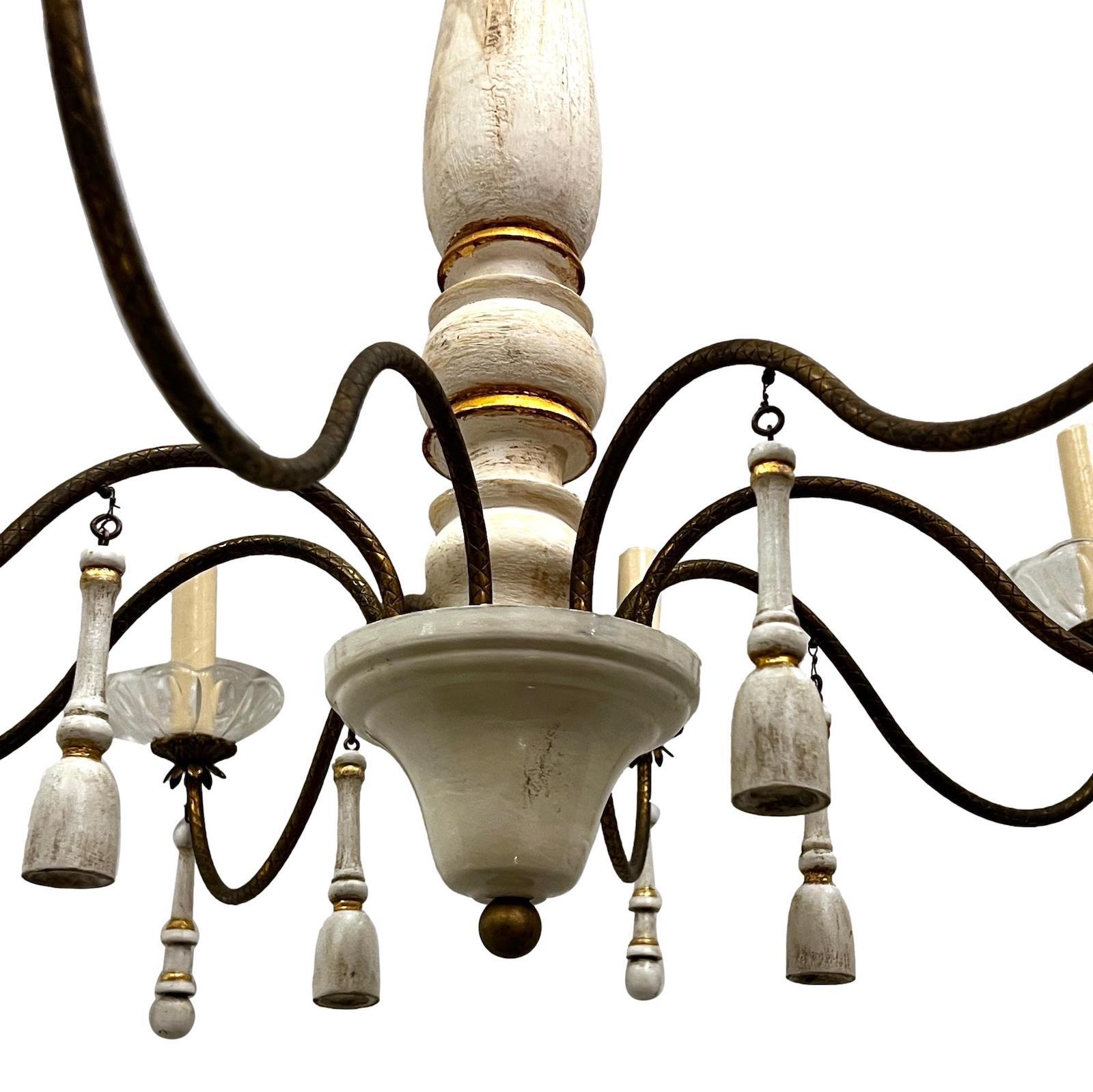 Italian circa 1940s eight-arm wooden chandelier with painted finished, carved wood tassels and crystal bobeches.

Measurements:
Minimum drop: 34