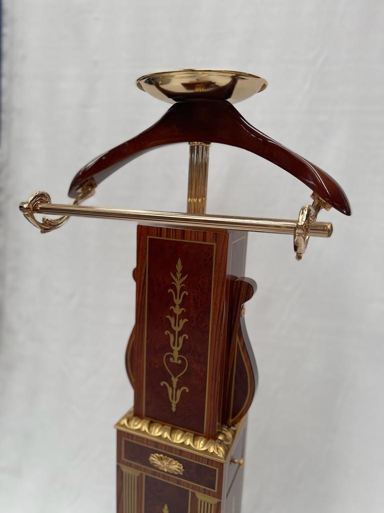 Italian coat stand, coat rack made out of engraved wood with gold-colored decorations. The top is made of bronze. There is a small drawer next to the item making it even more particular and unique.

Created by Mice Versailles (Italy).