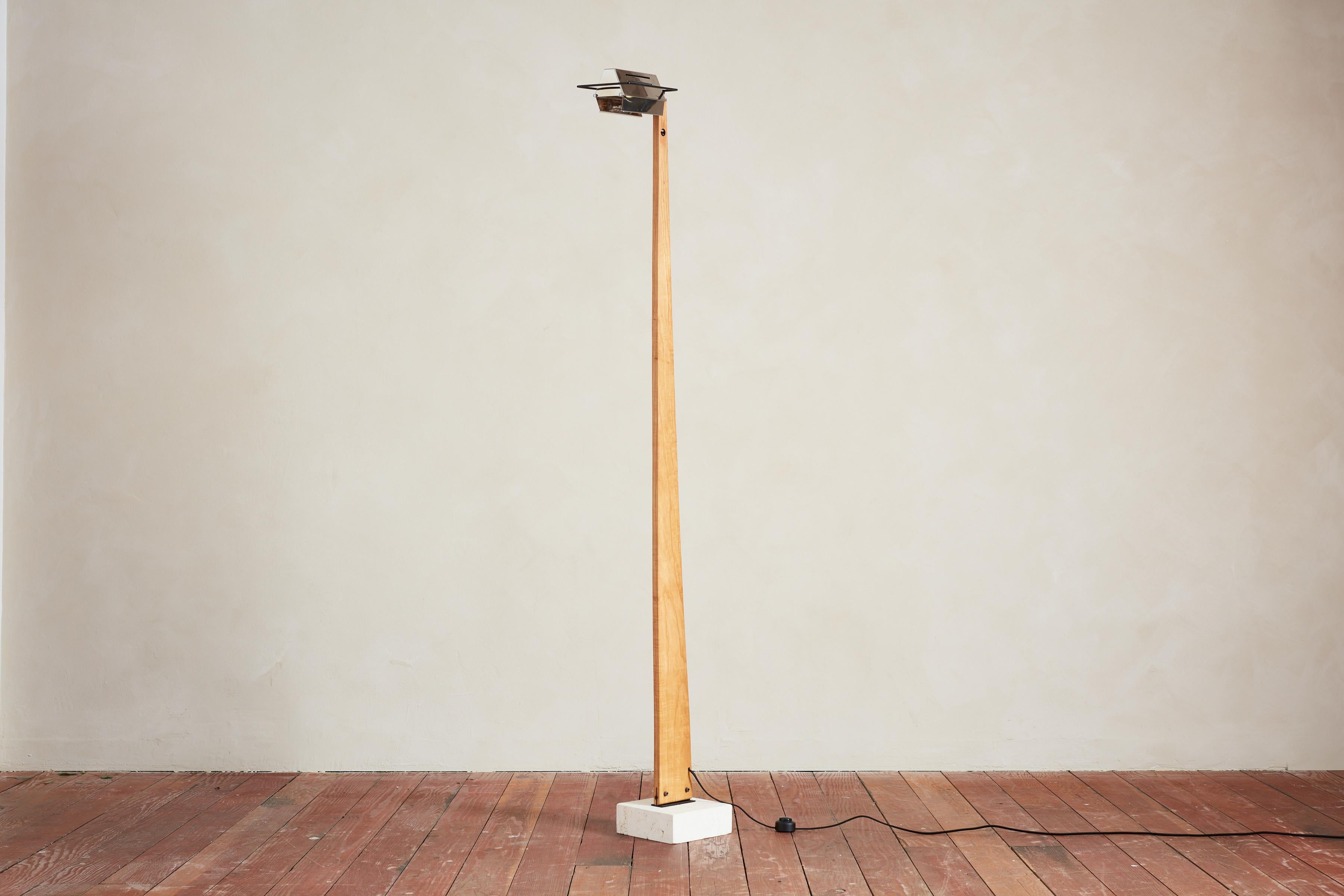 Interessante lampada da terra dalla struttura angolare con profilo semplice in legno e base in travertino.  Il Wood si assottiglia dalla base alla parte superiore che è collegata a un paralume industriale in metallo articolato. 

Ricablata di