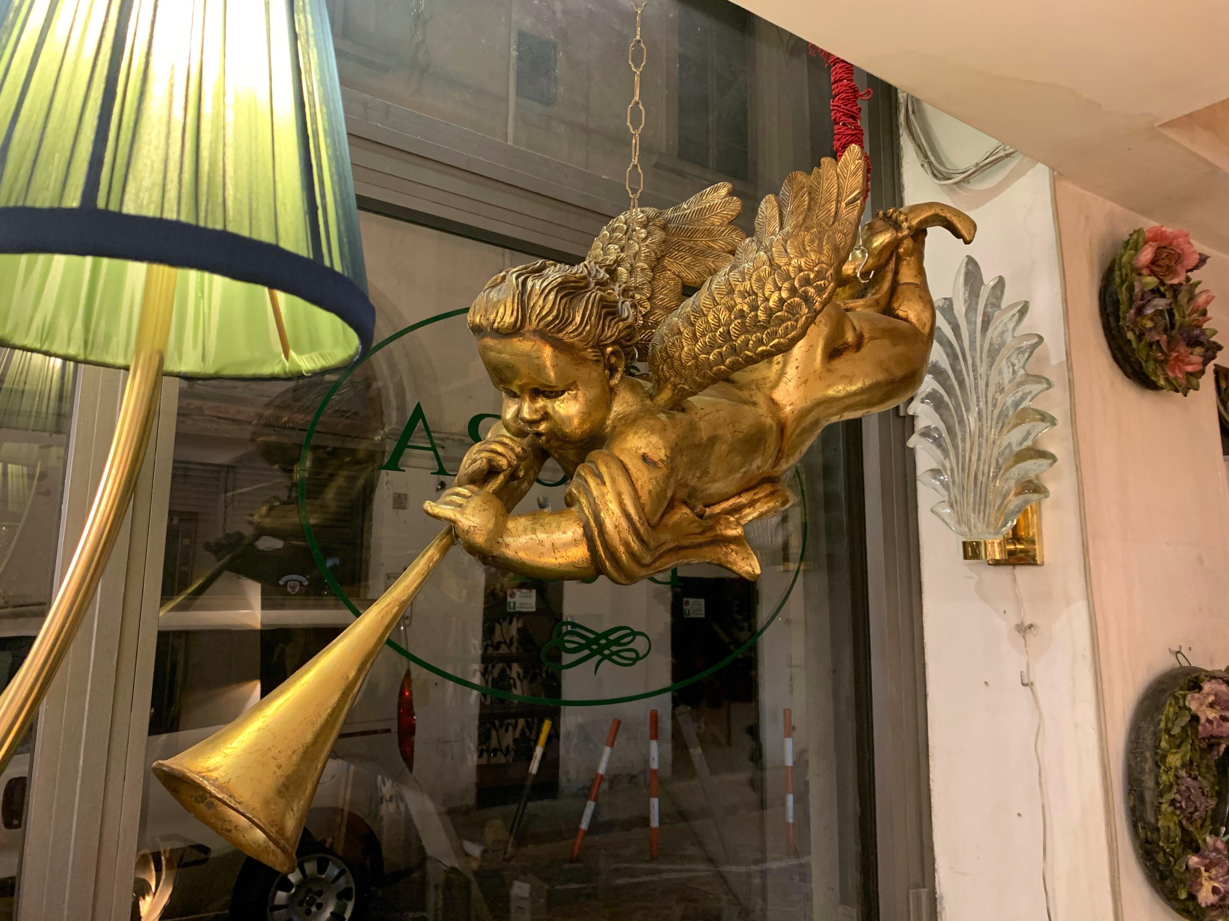 Italian wood gold leaf musician cherub, ceiling hanging Baby Angel. High decorative object the gold leaf has its original patina.