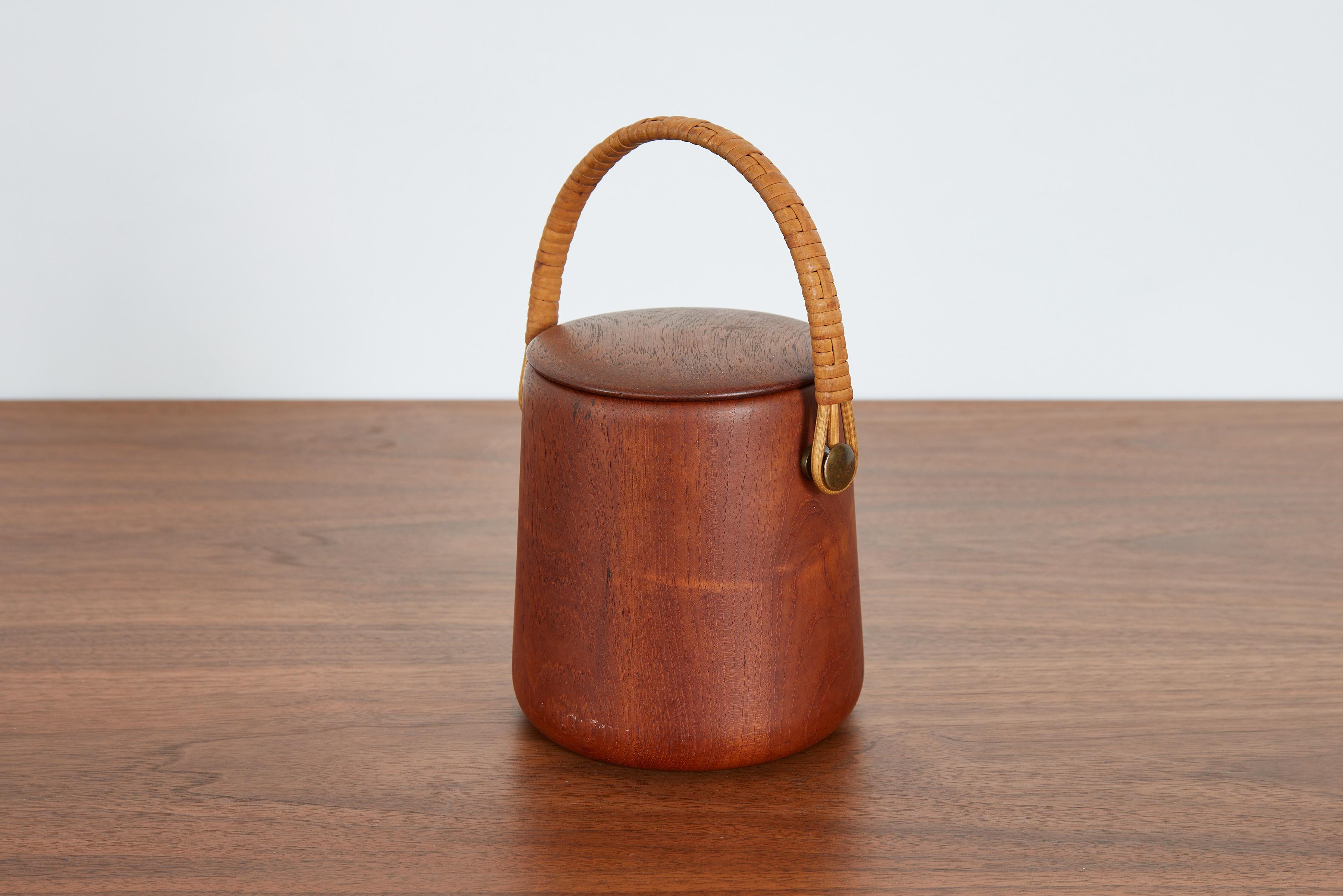 Chic Italian ice bucket in teak wood and woven rattan handle. 
Brass metal insert to hold ice 
Italy, 1950s
