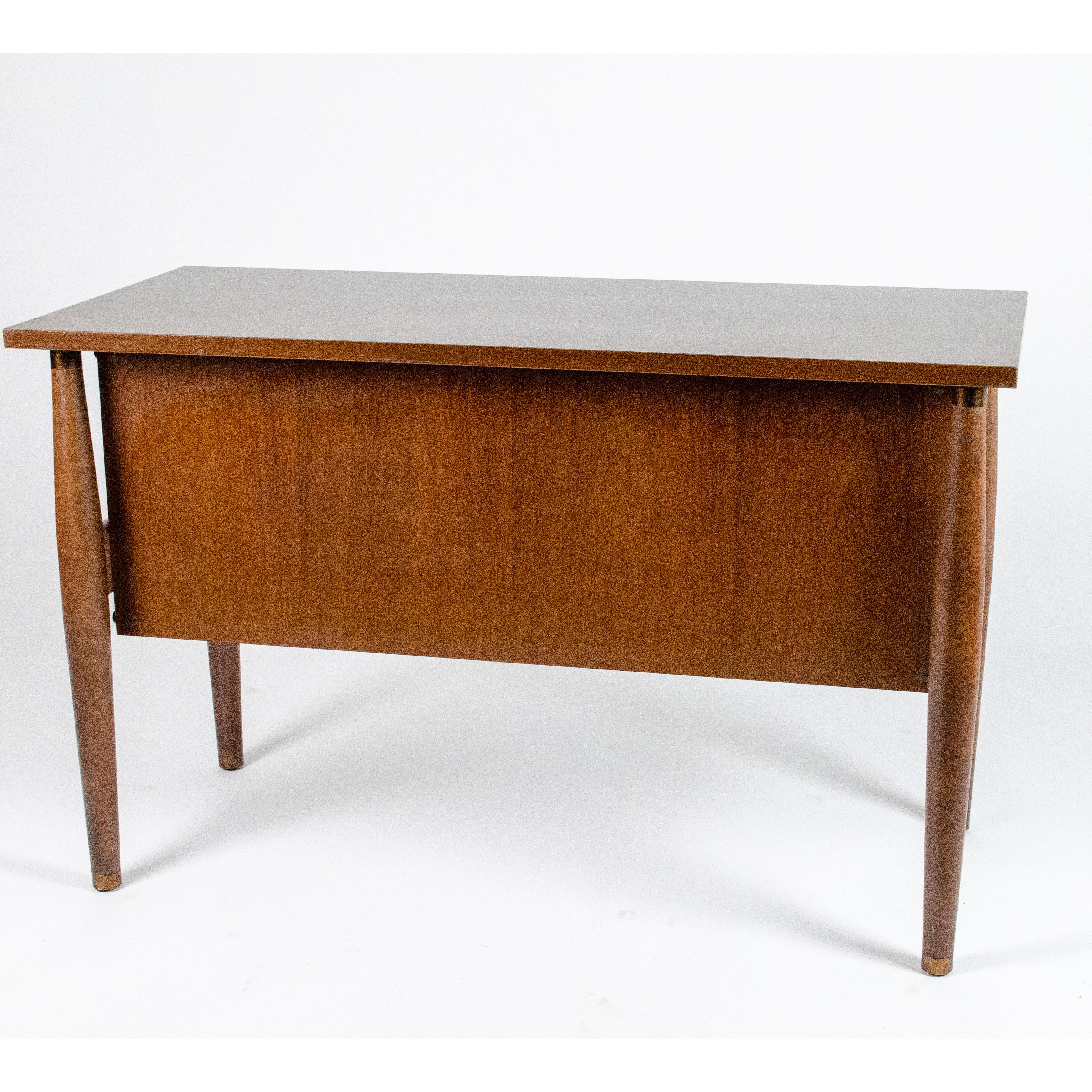 Italian 1960s wood and brown wood effect laminated top small desk with drawers. On each drawer is present the signature marked Schirolli Mantova. Legs are in wood. Good conditions, coherent with age and prior use, no structural damage only few small