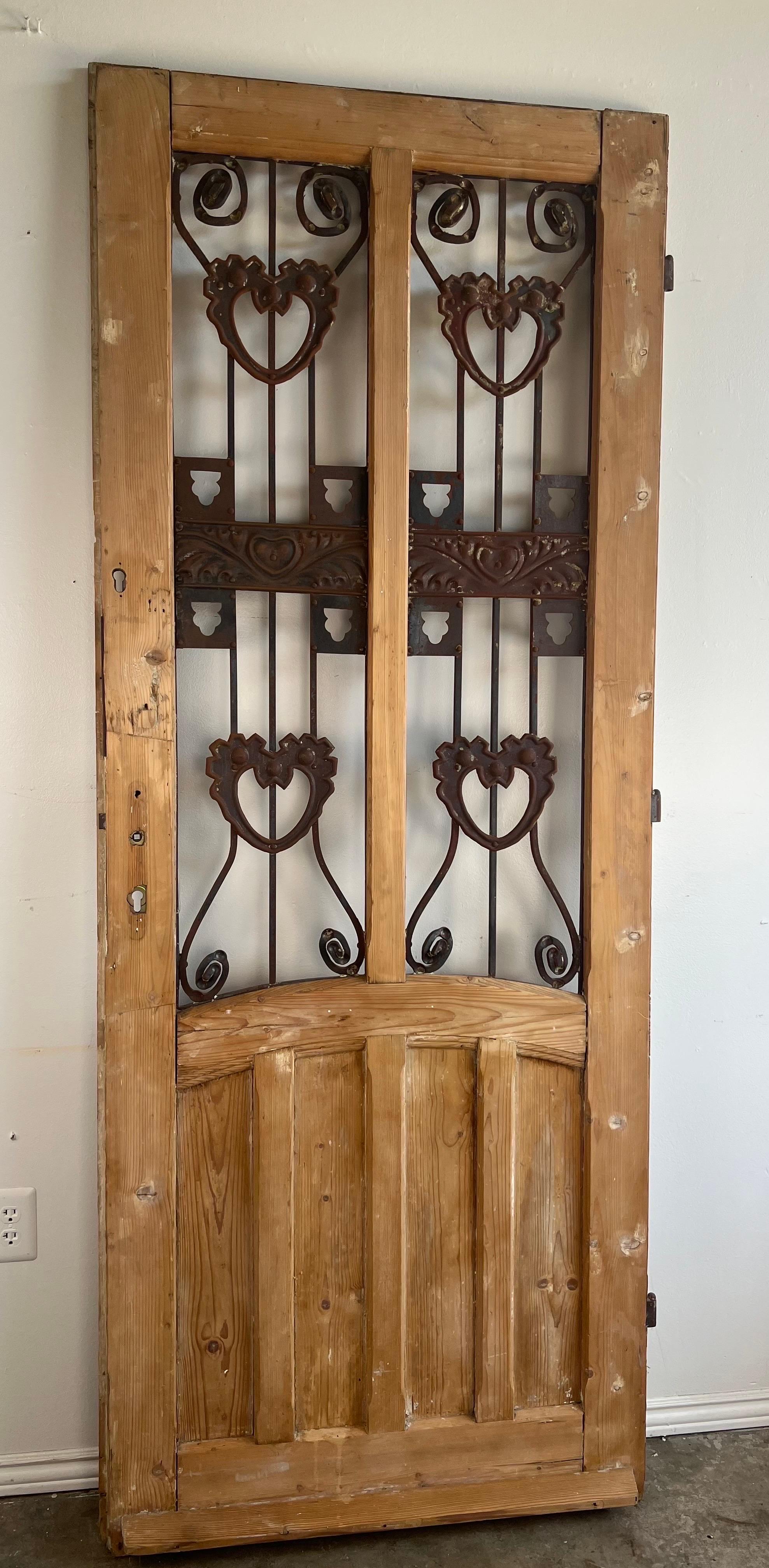 Early 20th century  pine & wrought iron door.  The door had hand forged iron depicting hearts, acanthus leaves and so much more.