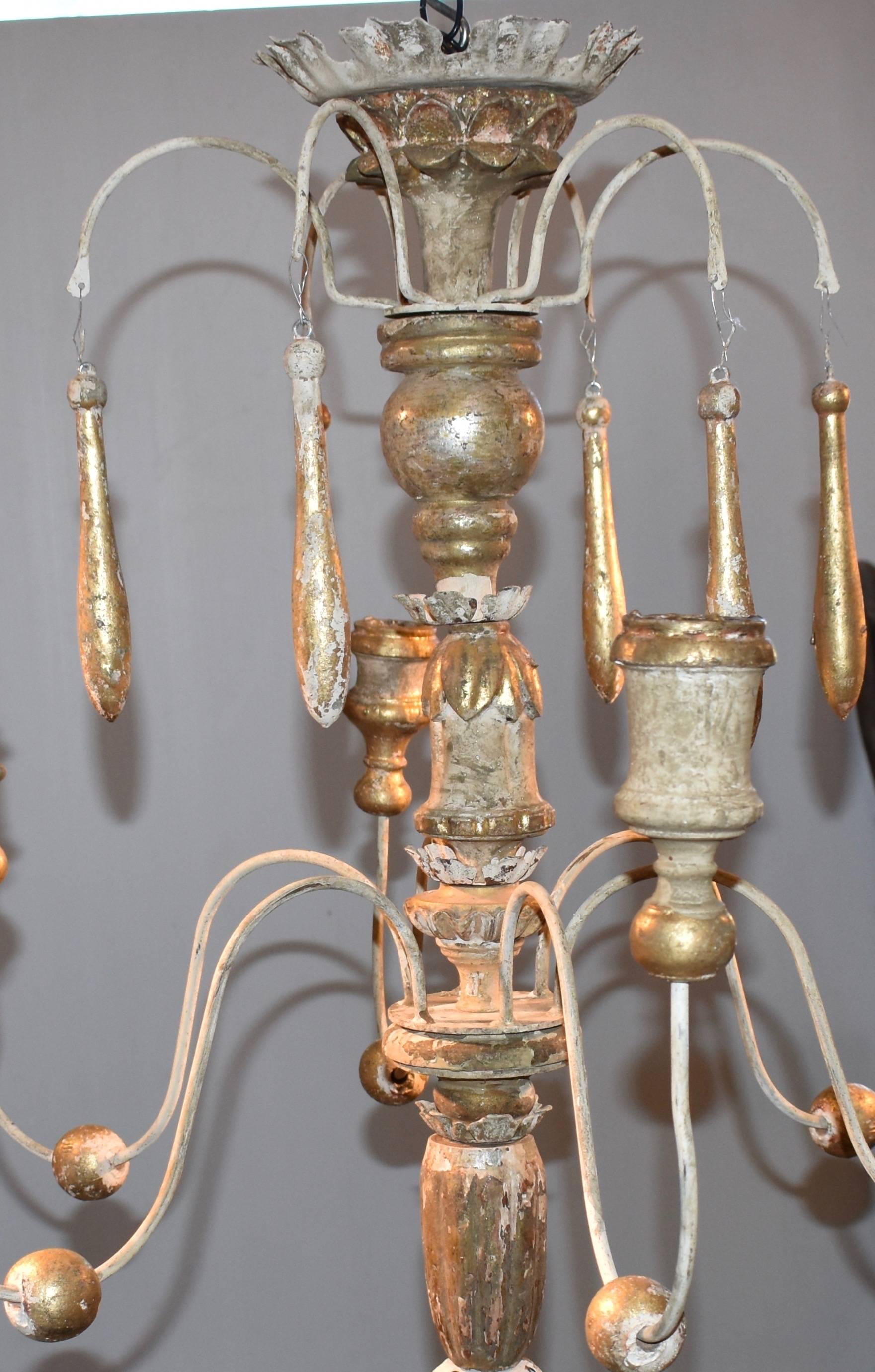 Beautiful wooden chandelier made from 18th century Italian church candlesticks. Great aged patina. Lovely cream white with hints of gilded gold color. Not yet wired. Check out my other listing of a similar chandelier, the two could make a great pair.
