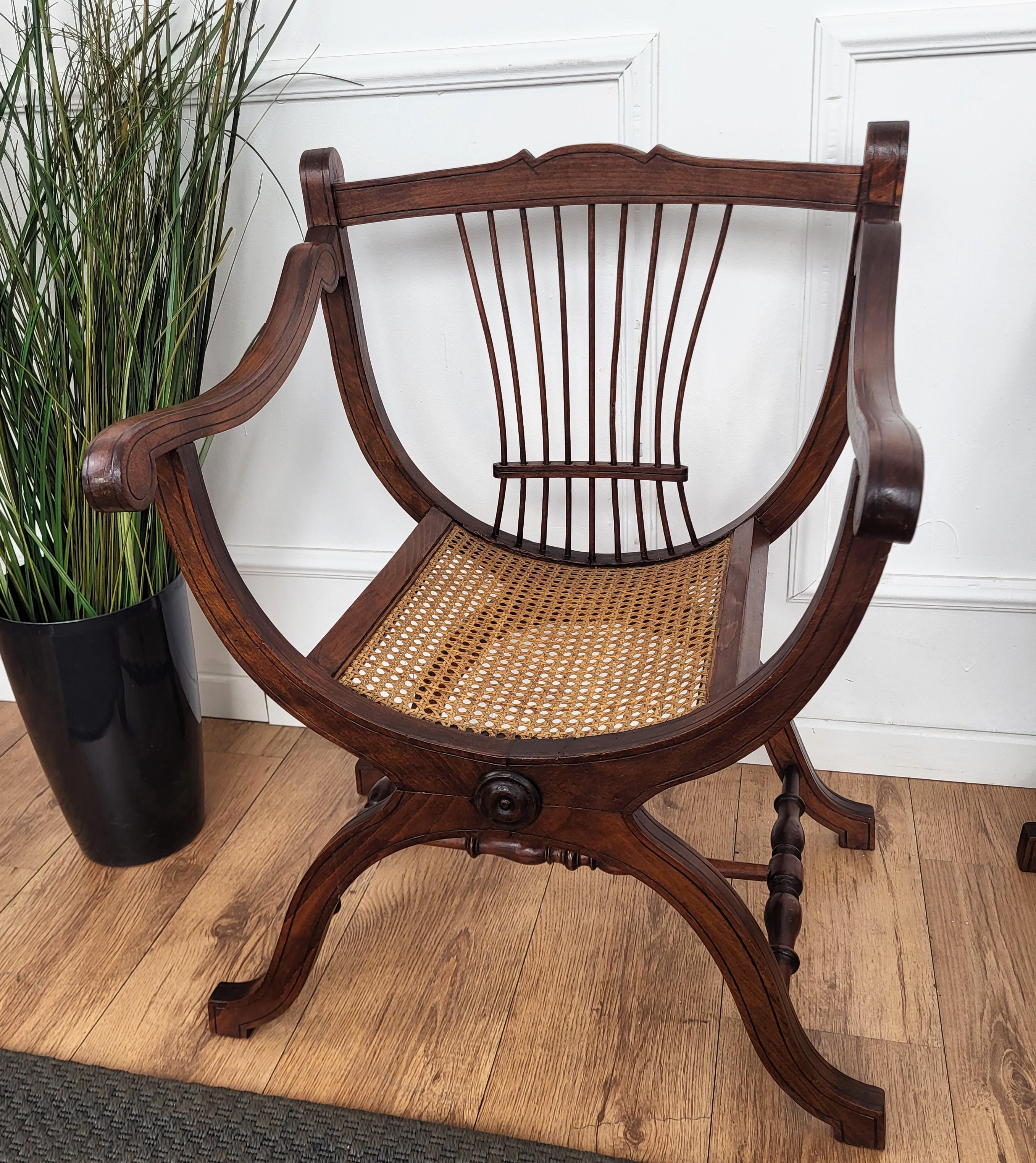 A beautiful and sleek Italian wooden and cane side chairs of great quality with excellent profile carvings and detail decors. A Savonarola design with back slatted detail decor. A great and elegant living room pair, ideal as well as hallway end