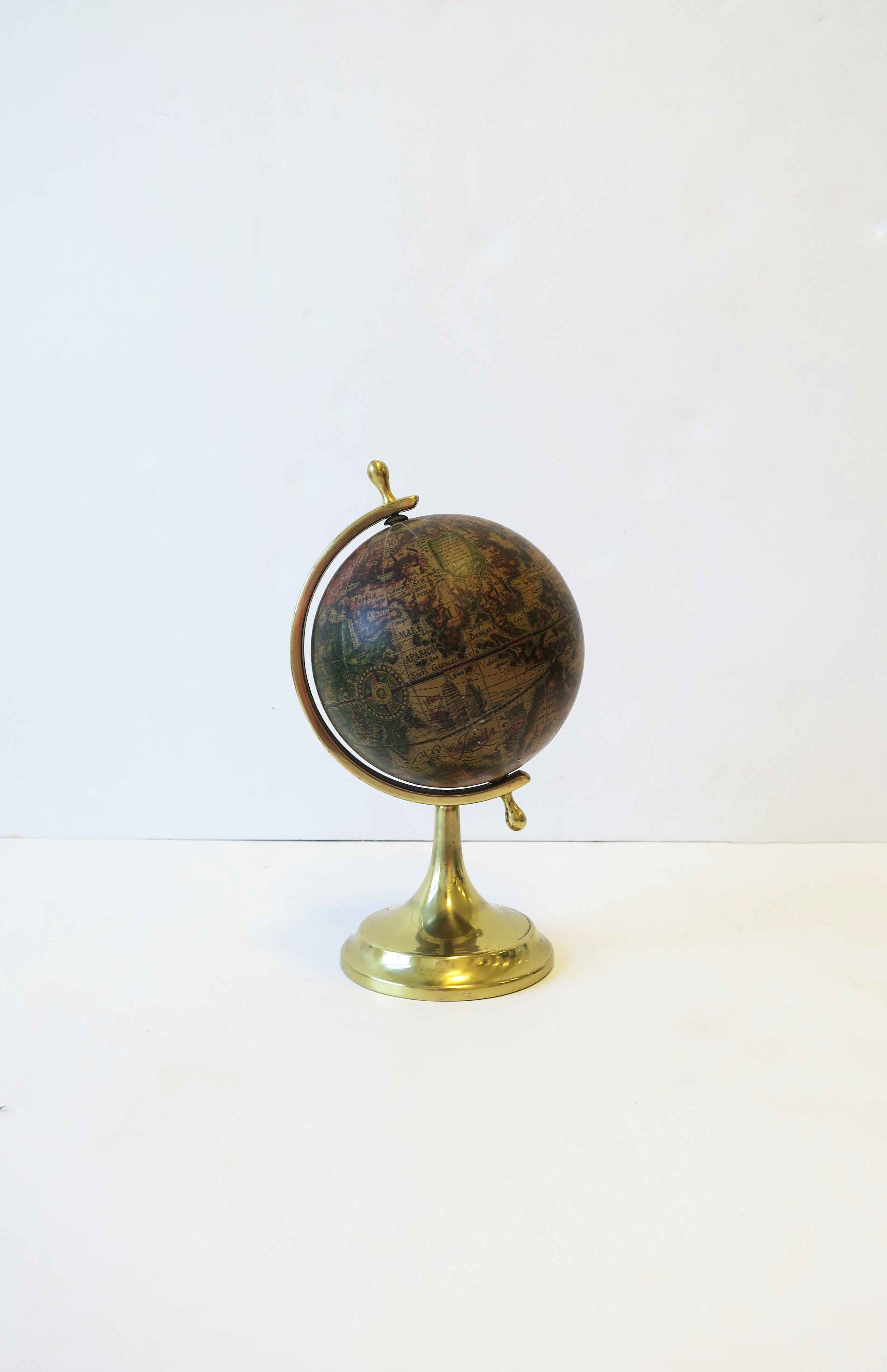 An Italian mid-20th century world globe that spins. Piece has a brass base and hardware. Marked 