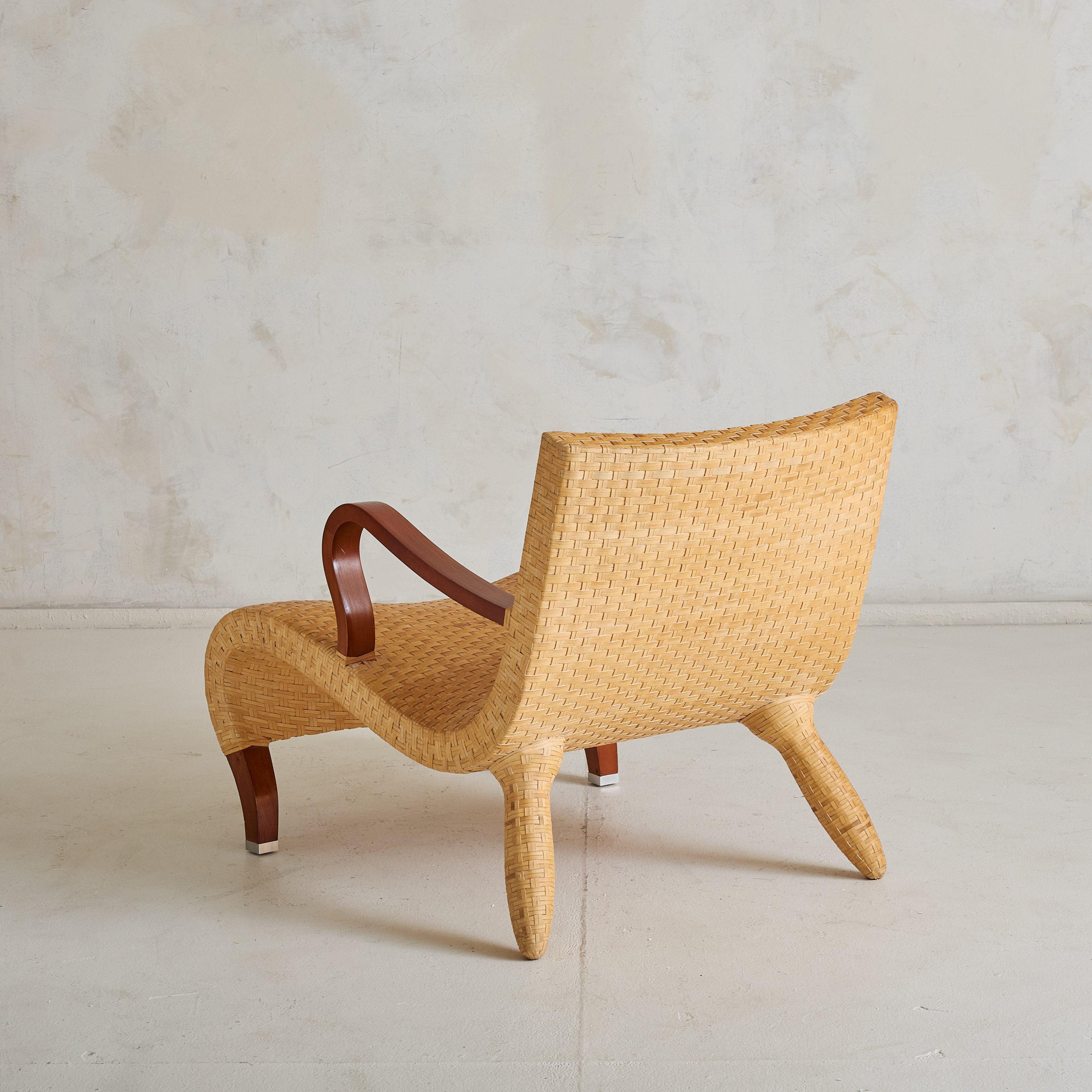 This sculptural armchair embodies the essence of 1970s Italian design. Created by Antonio Citterio for the now-iconic Compagnia delle Filippine collection by B&B Italia, it features a fluid silhouette accentuated by narrow, handwoven strips of water