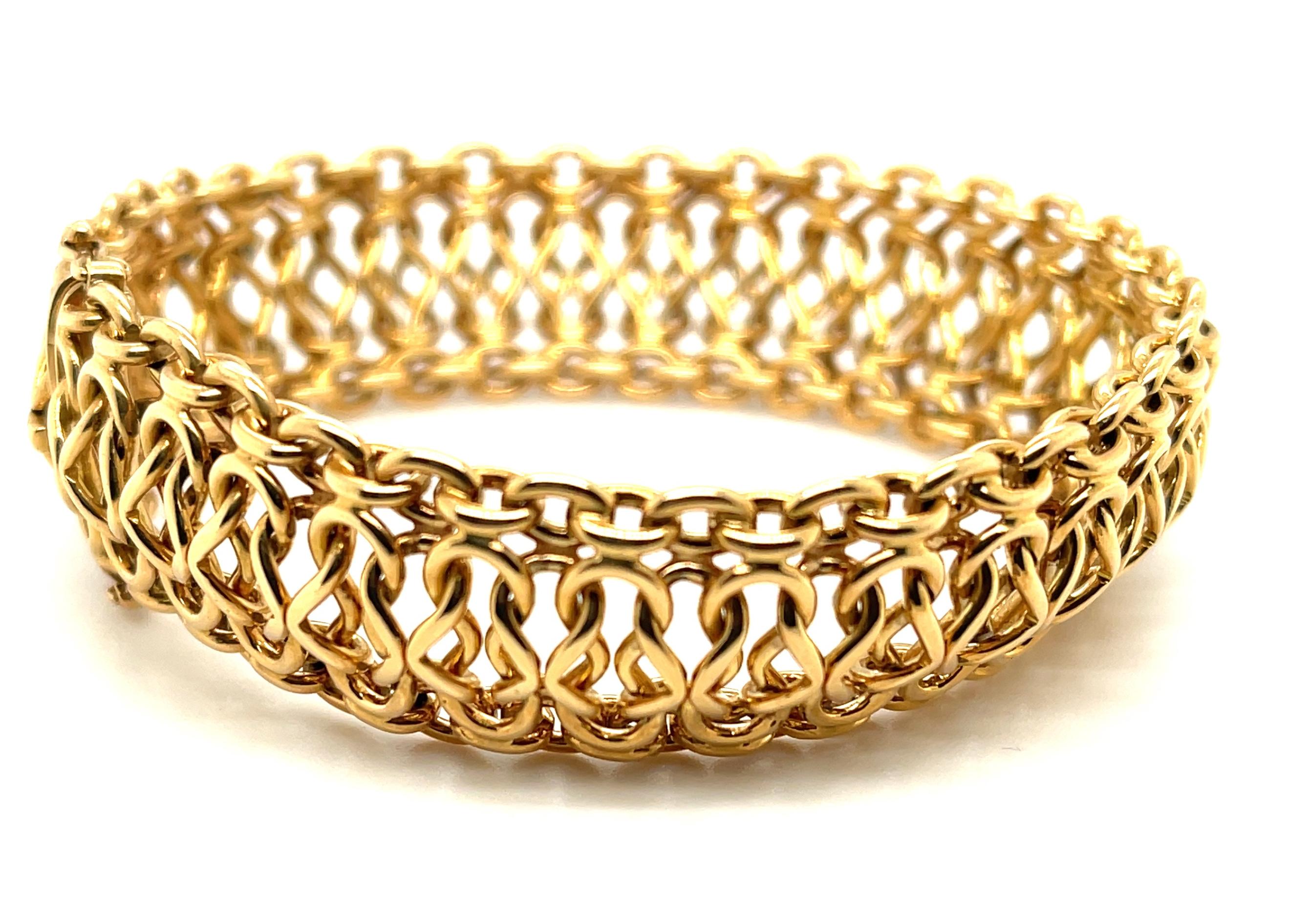 This stunning Italian gold bracelet has the look and feel of pure luxury! Beautifully interwoven links of high-polished 18k yellow gold create wonderful visual and actual movement, in an ultra-comfortable design that makes this bracelet a pleasure