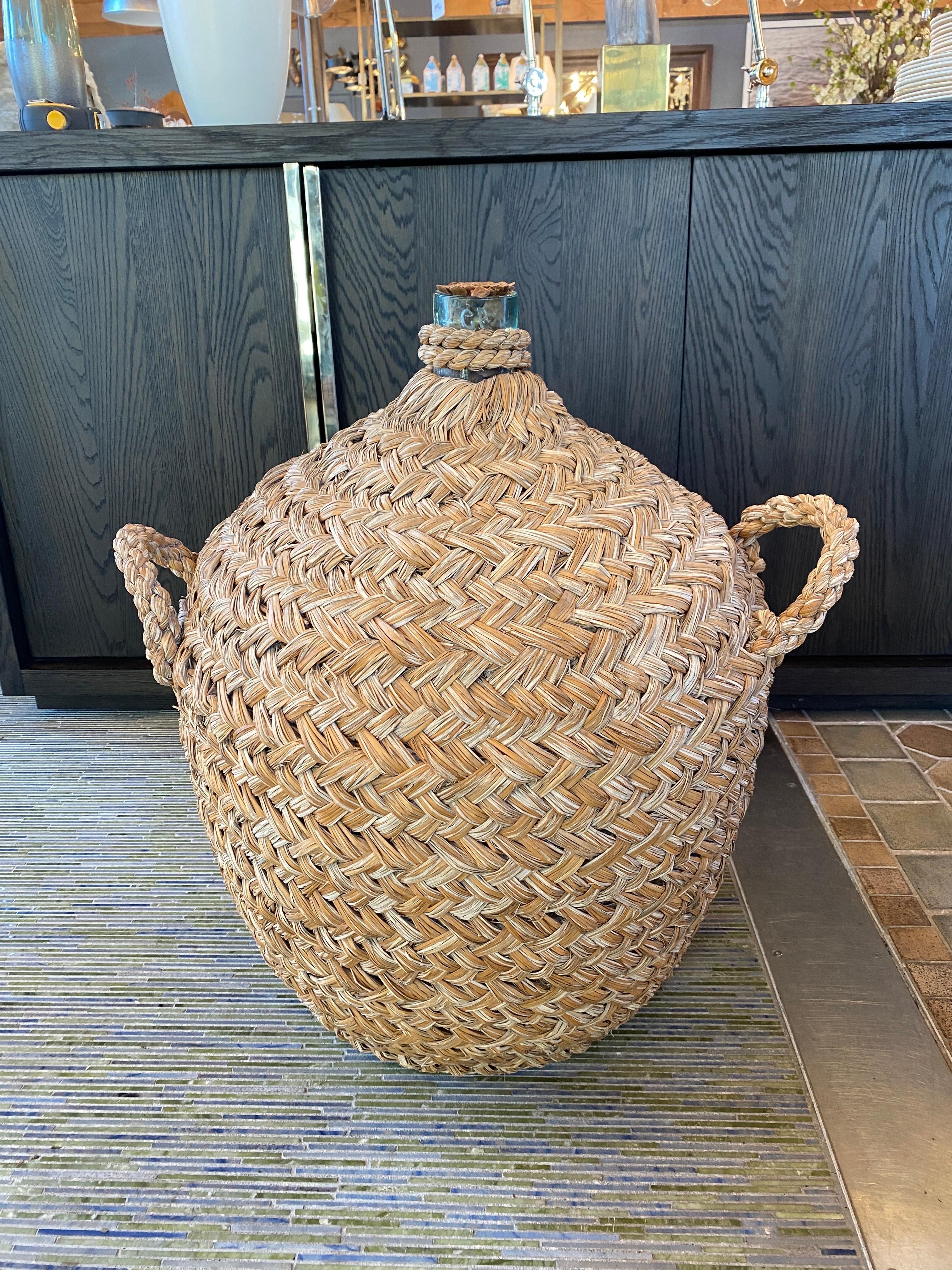 Italian woven seagrass wine bottle.

Gorgeous weave with three handles and pinecone design on top.