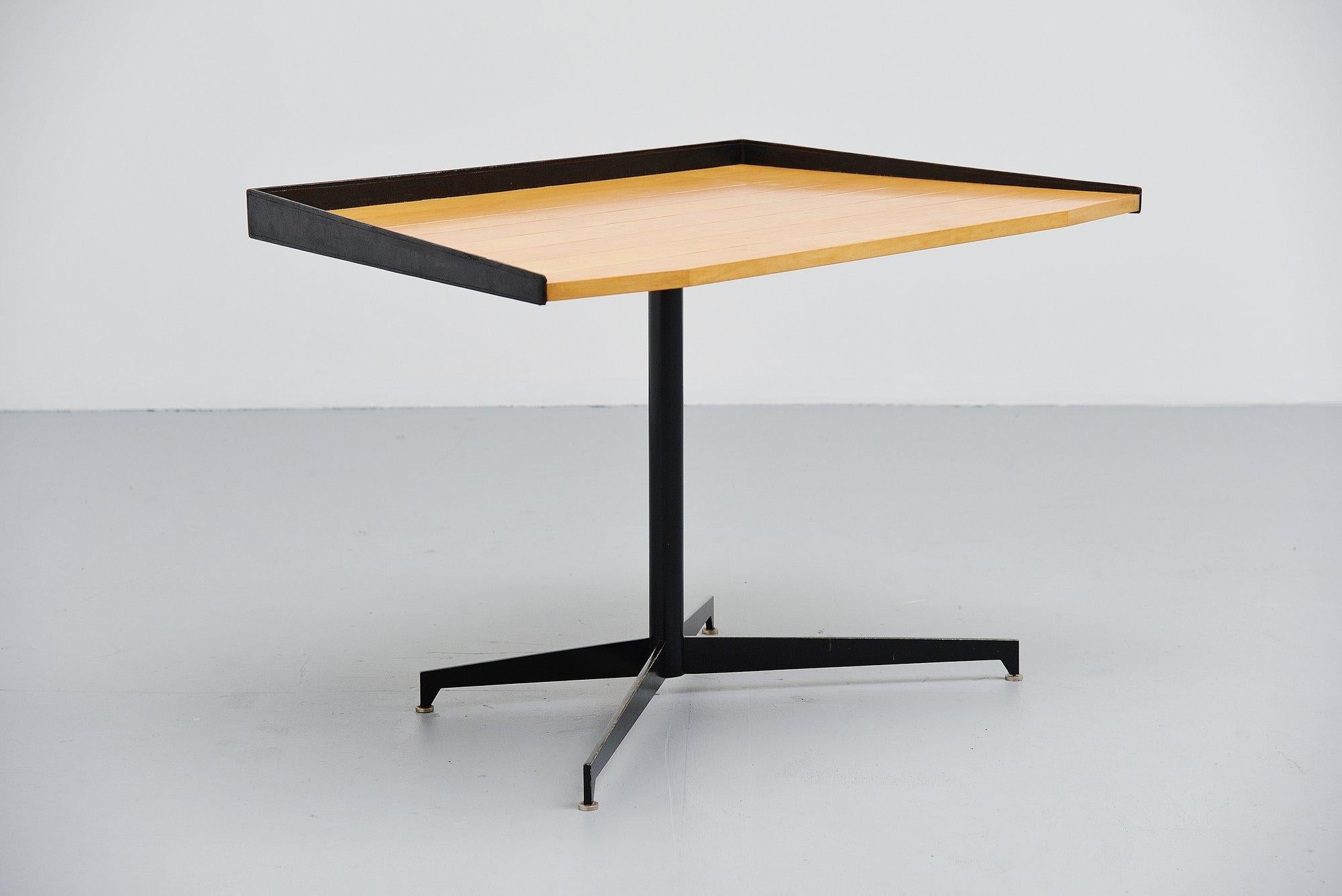 Fantastic shaped small writing desk in the manner of Osvaldo Borsani for Tecno, Italy, 1950. This desk has a black painted metal frame with cross shaped base. The top is made of birch plywood veneer and the edges are made of black leather. Very nice