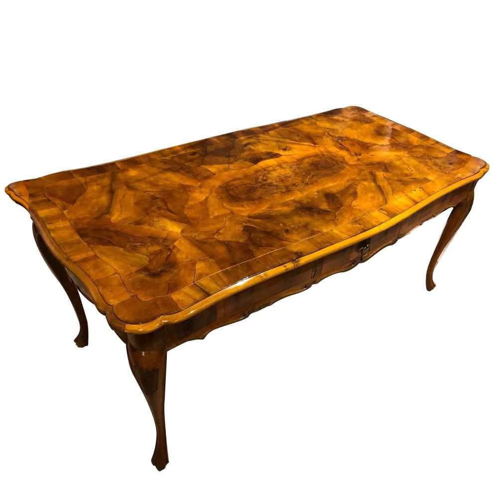 A mid-19th century Italian walnut writing table with cabriole legs.

Measurements:
Length (side to side) 71