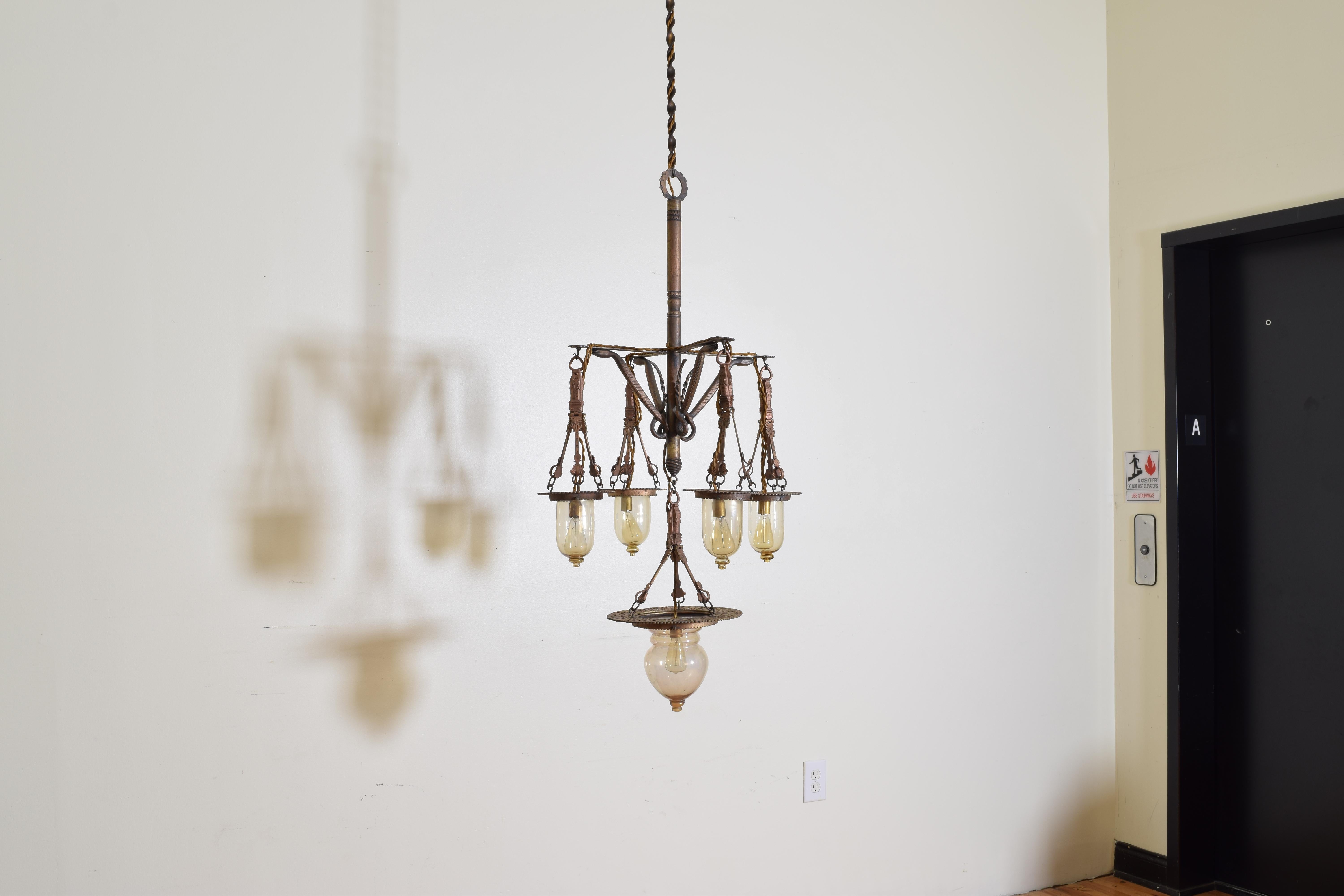 Originally an oil lantern and probably from Venice, Italy, with 4 arms connected to the central standard by horizontal brackets and diagonal decorative serpents, each end with a hanging glass globe, the bottom of the chandelier issuing one larger