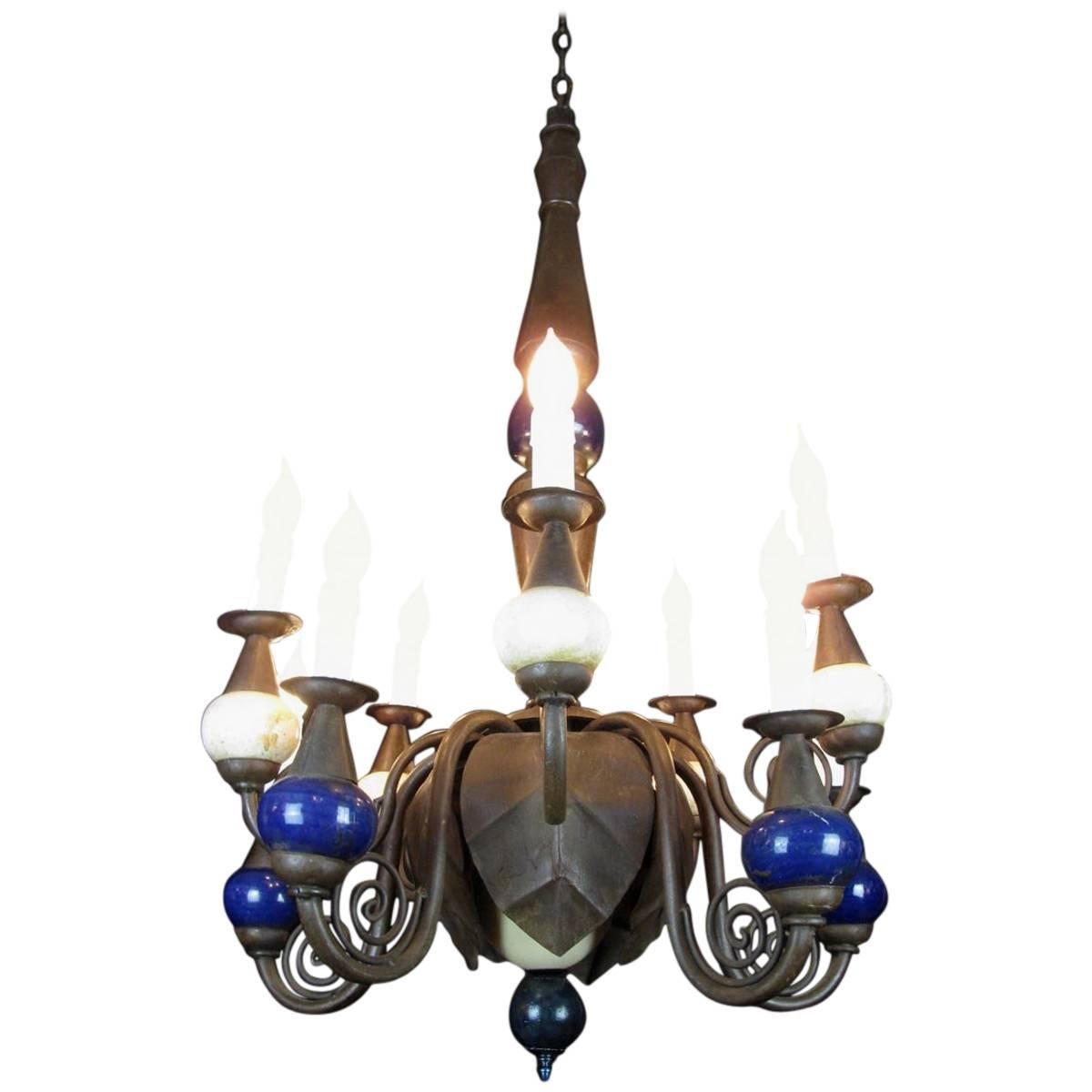 Early 20th century Italian iron two-tier ten-light chandelier, in good condition, restored and rewired. Of Italian origin, handcrafted, this is a unique work of art coming from a Milanese private palazzo.
Unusual structure with ten curved scrolling