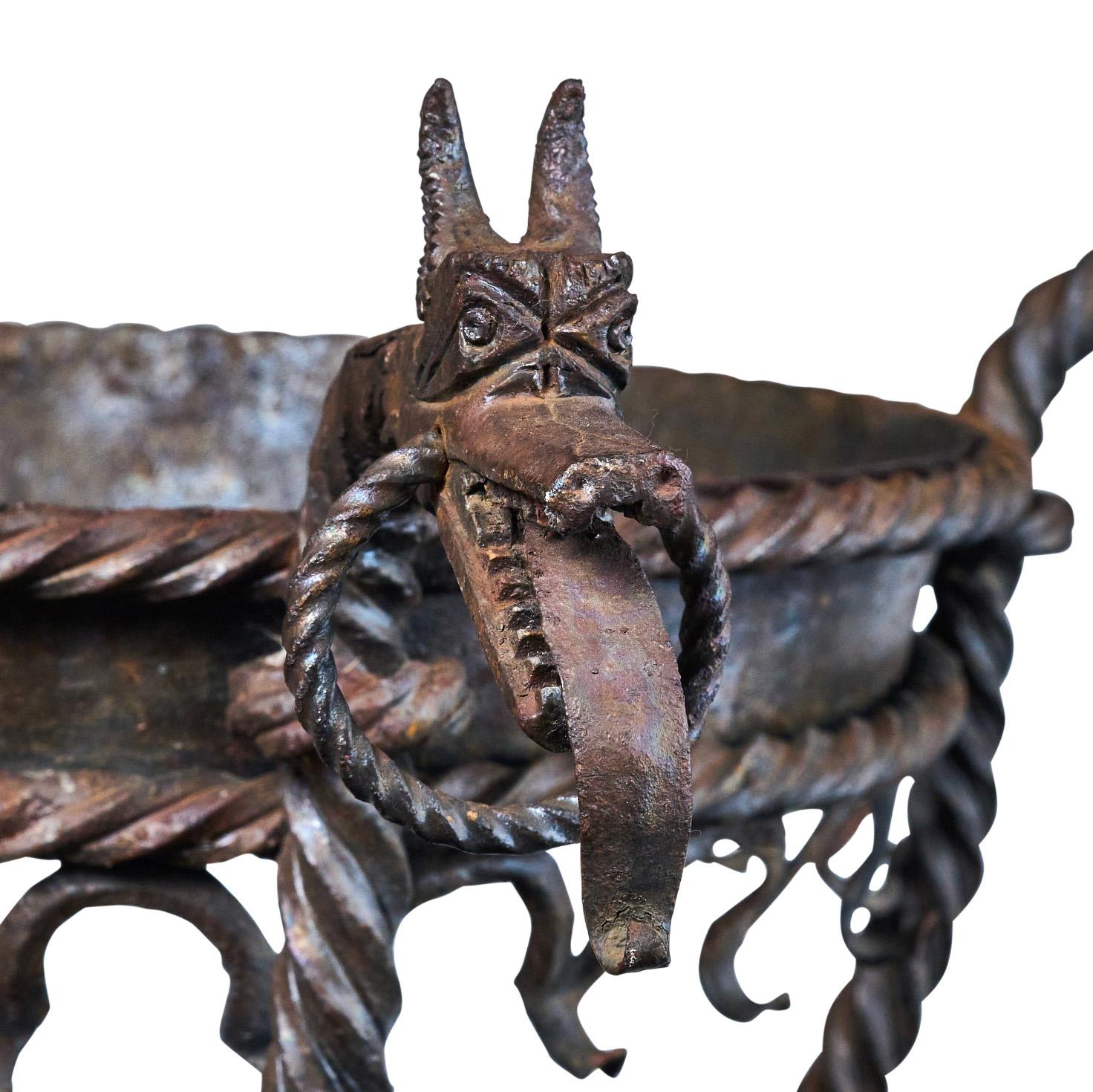 Wrought iron planter with decorative beastie heads. Great condition and quality. 