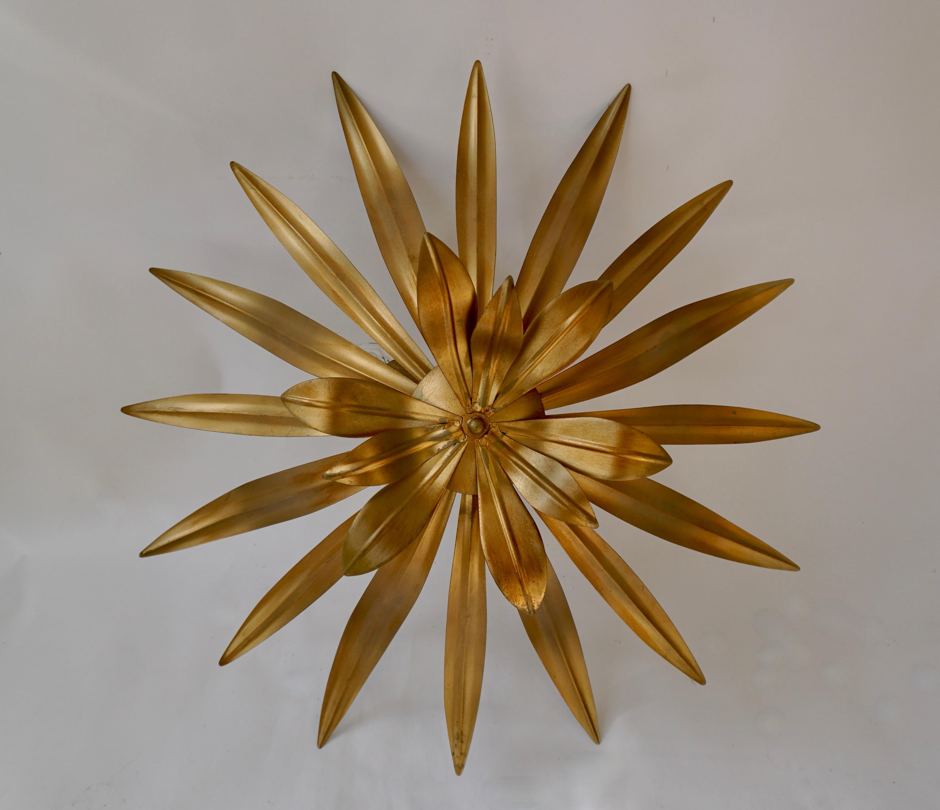Botanical style meets a modern look in this 4-light statement semi-flush mount. Crafted from steel, it features a plant-inspired design with a curving shade made from leaf-like fronds hanging from a central arm and a circular canopy. A luminous