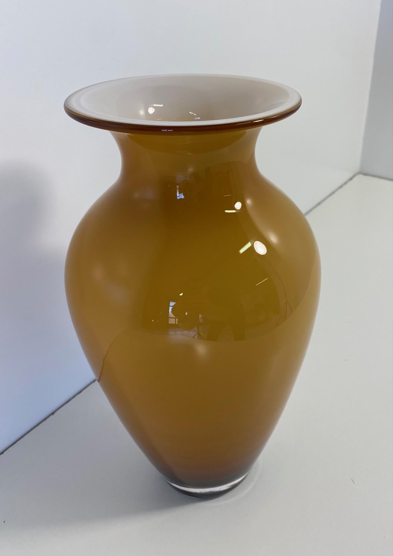Blown and encased glass vase (amber yellow exterior and milky white interior) with opal glass layer. 

The nuance of the amber yellow color is very particular.

Stamped 'Nason C.' (Carlo Nason) under the base.