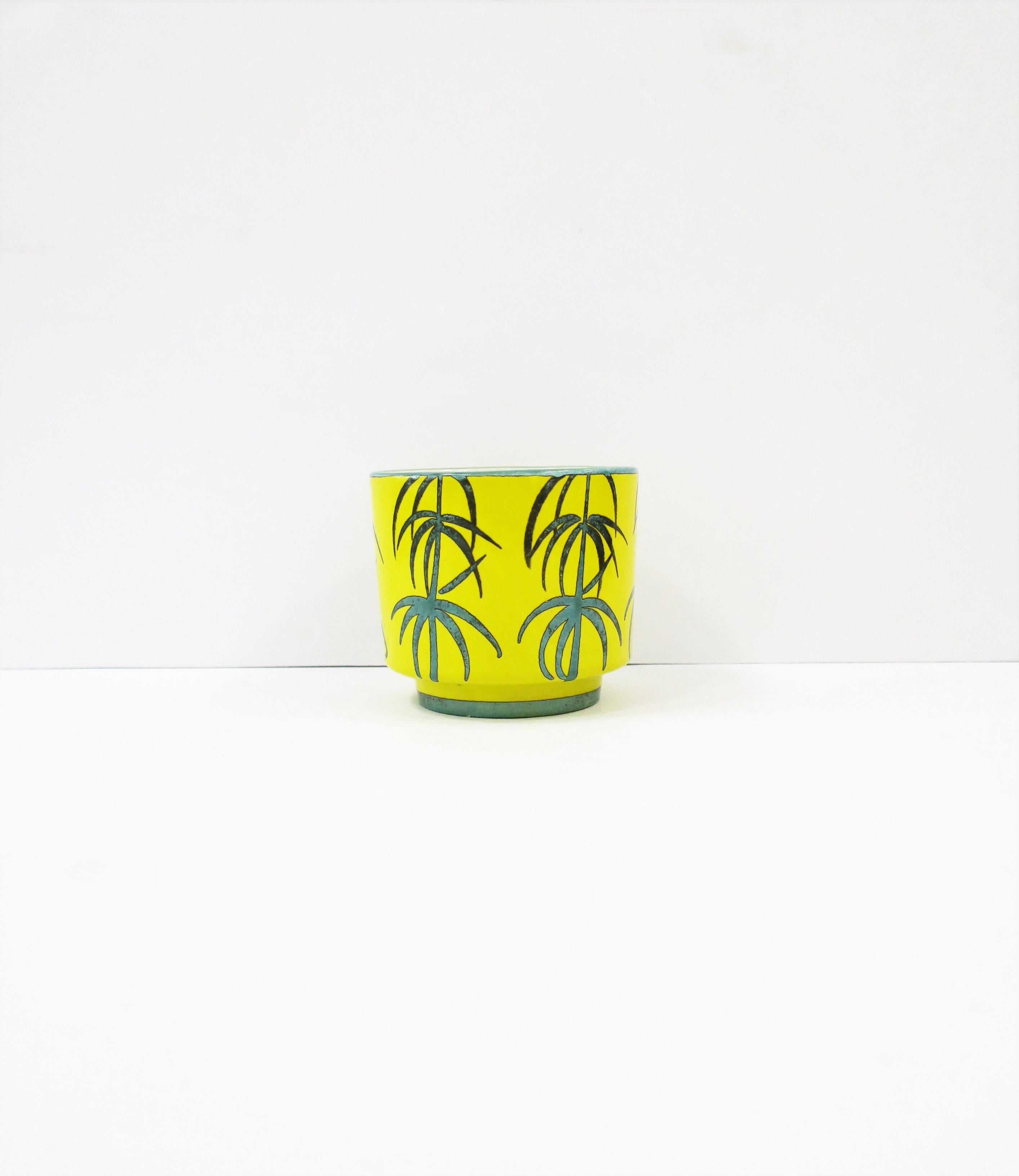 A beautiful bright yellow Italian ceramic jardinière cachepot planter or flower pot holder with modern palm tree design, circa late-20th century, Italy. Marked/imprinted 