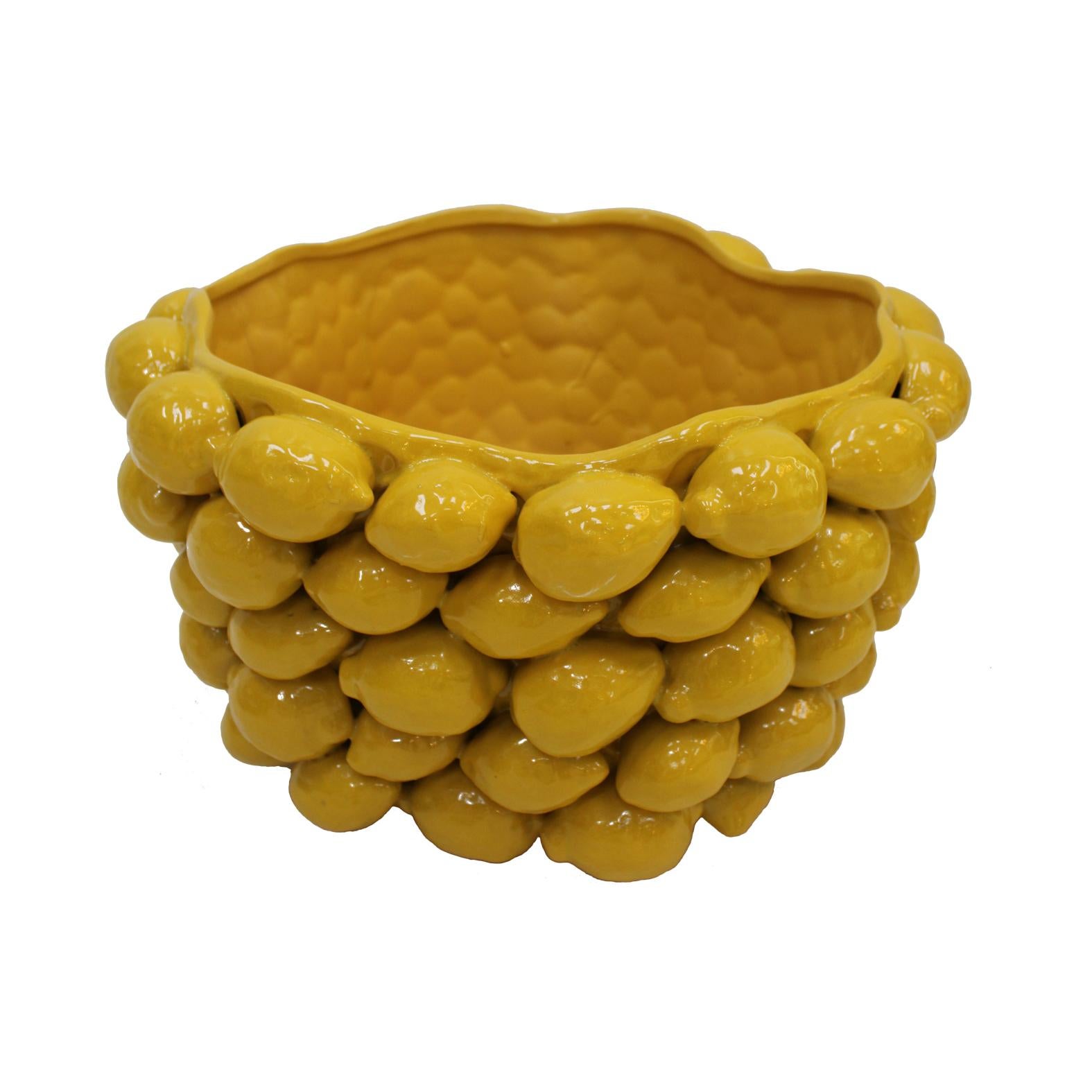 Art vase made by hand in yellow glazed ceramic with traditional lemon motifs from southern Italy.
Contemporary Italian art vase in stock.

Transform your living space with our exquisite contemporary Italian Yellow Fruit Motif Ceramic Vase. Crafted